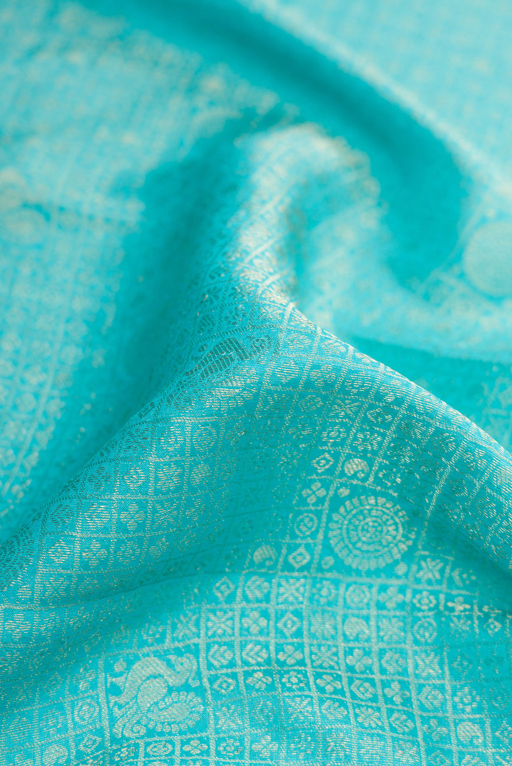 Close up of Sky Blue Dual Tone Mysore Crepe Saree with Zari Brocade on the body and Zari Border.  displaying folds
