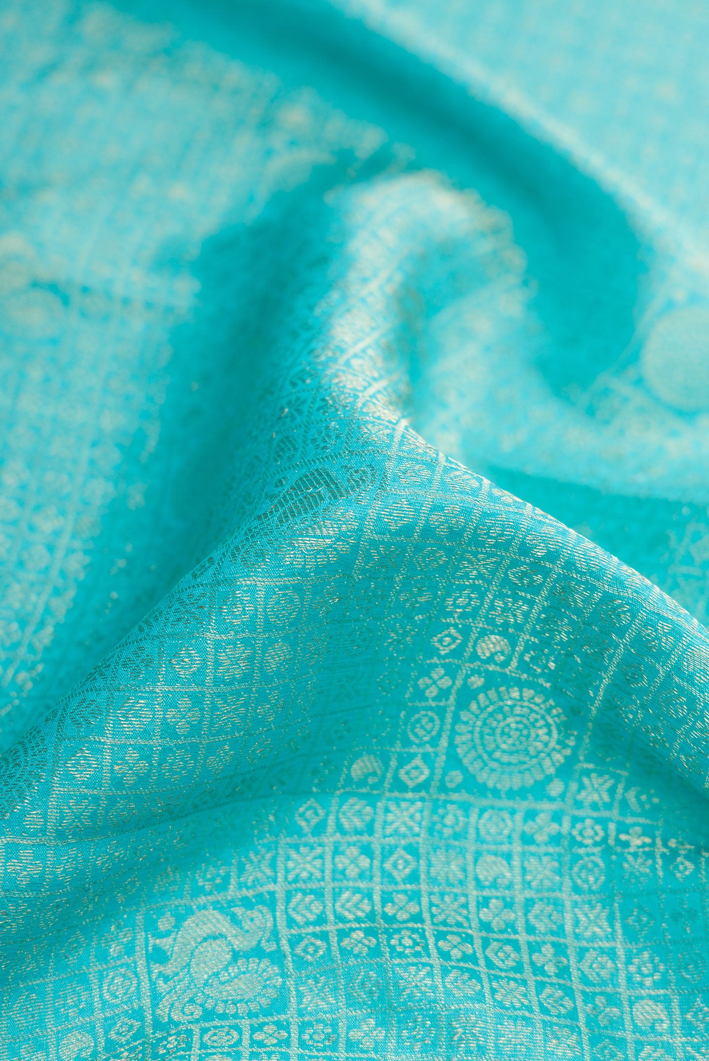 Close up of Sky Blue Dual Tone Mysore Crepe Saree with Zari Brocade on the body and Zari Border.  displaying folds