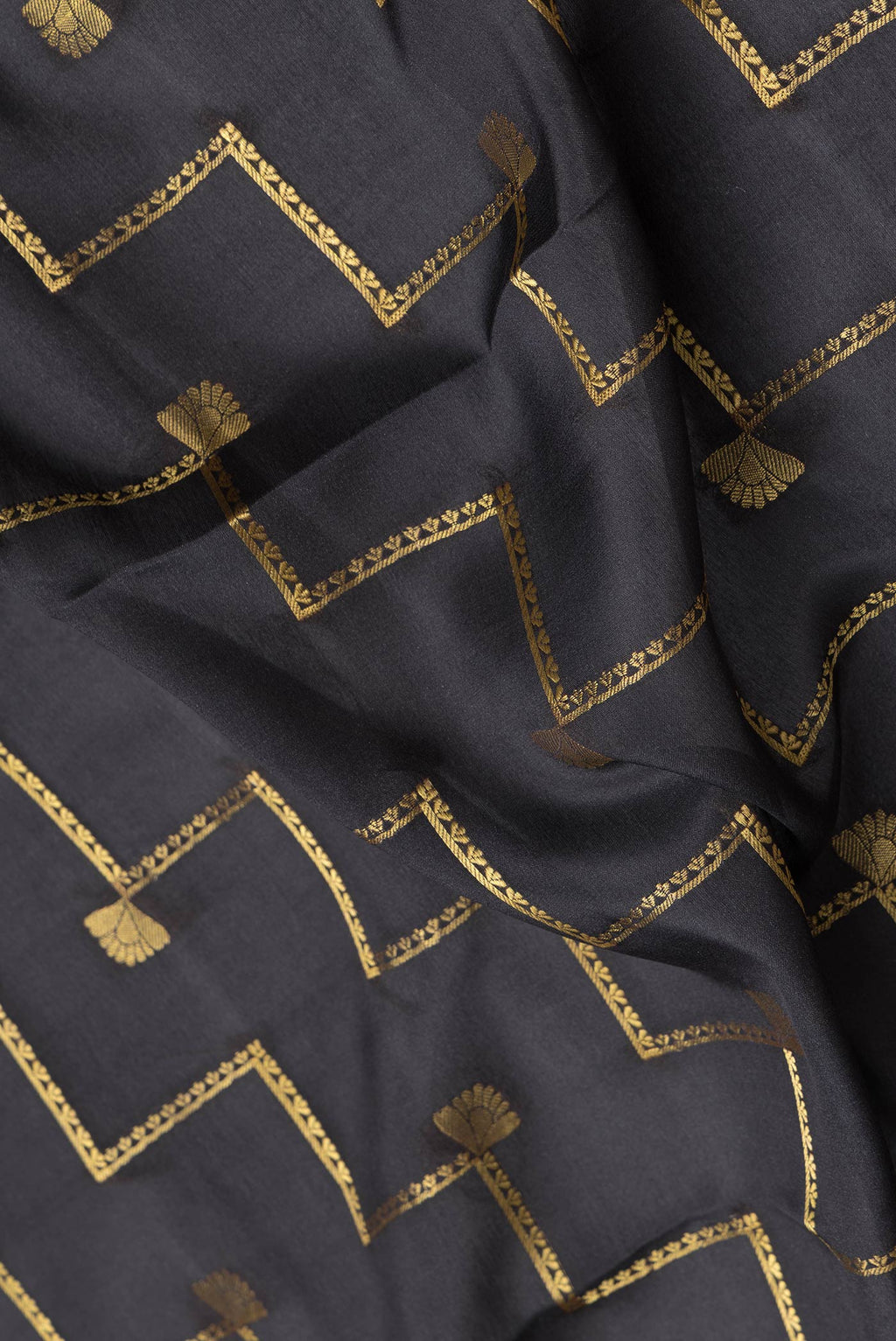 Close up of Black Dual Tone Mysore Silk Saree with Zari Butta on the body and Fancy Border.  displaying folds