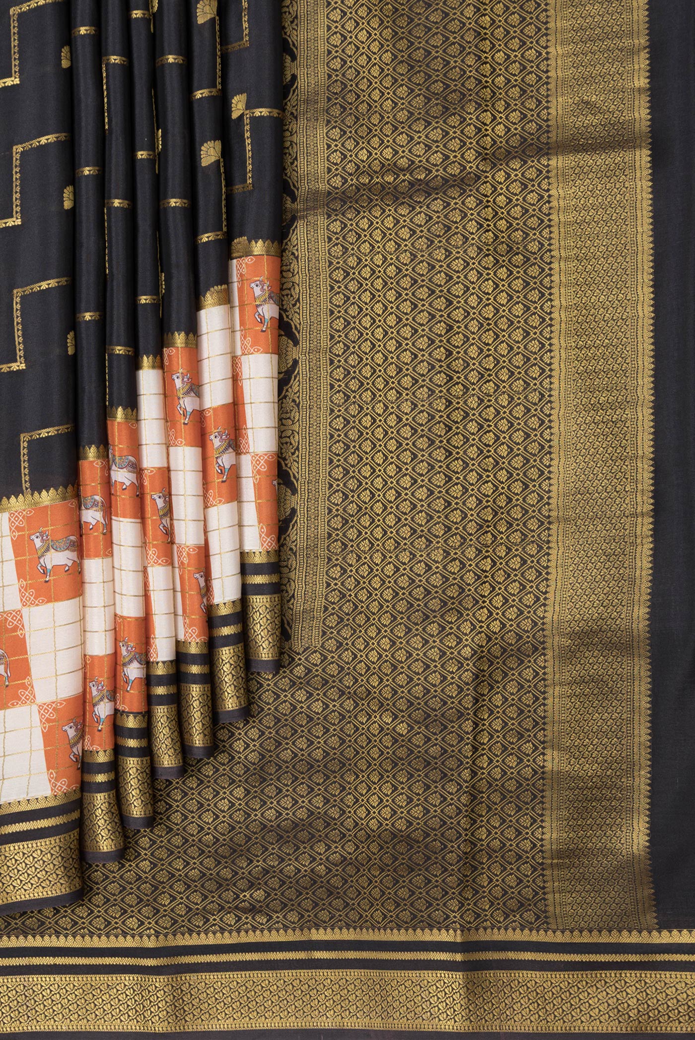 Pleats and pallu of Black Dual Tone Mysore Silk Saree with Zari Butta on the body and Fancy Border. 