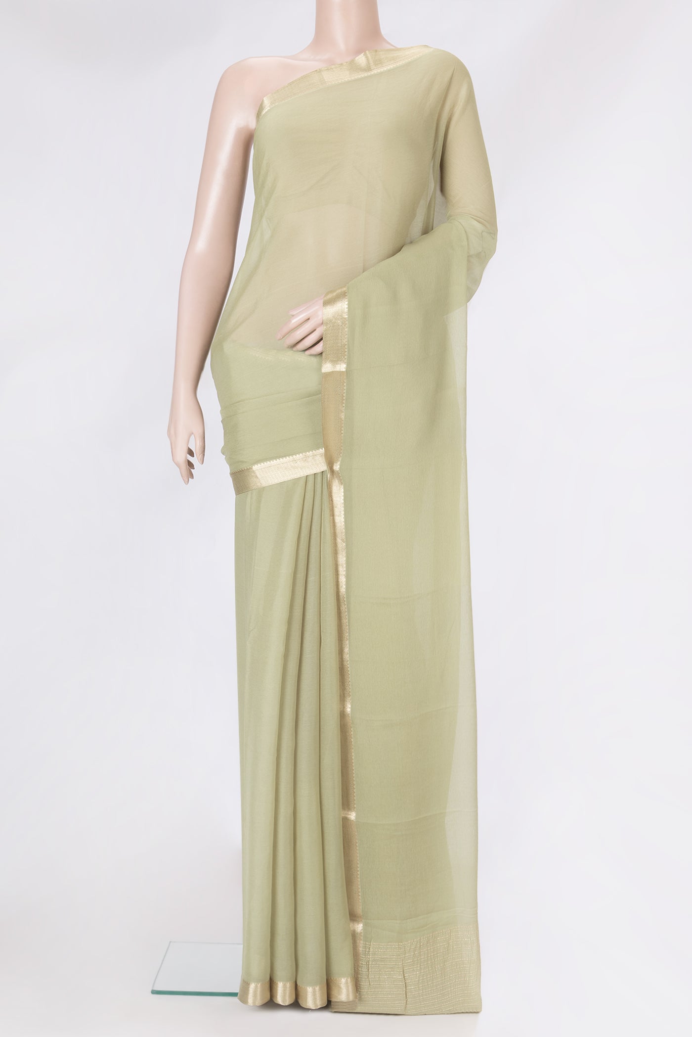 Pista Green Mysore Chiffon Saree with Plain Body and Zari Border.  displayed on a mannequin