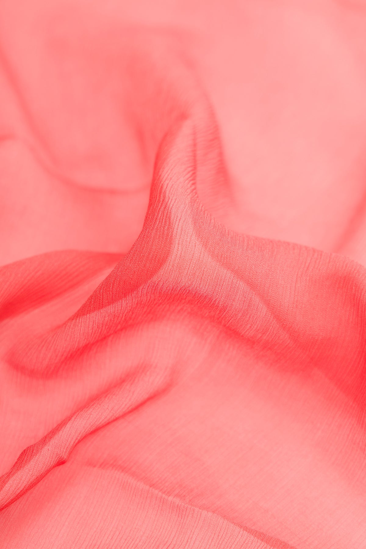 Close up of Peach Dual Tone Mysore Chiffon Saree with Plain Body and Zari Border.  displaying folds