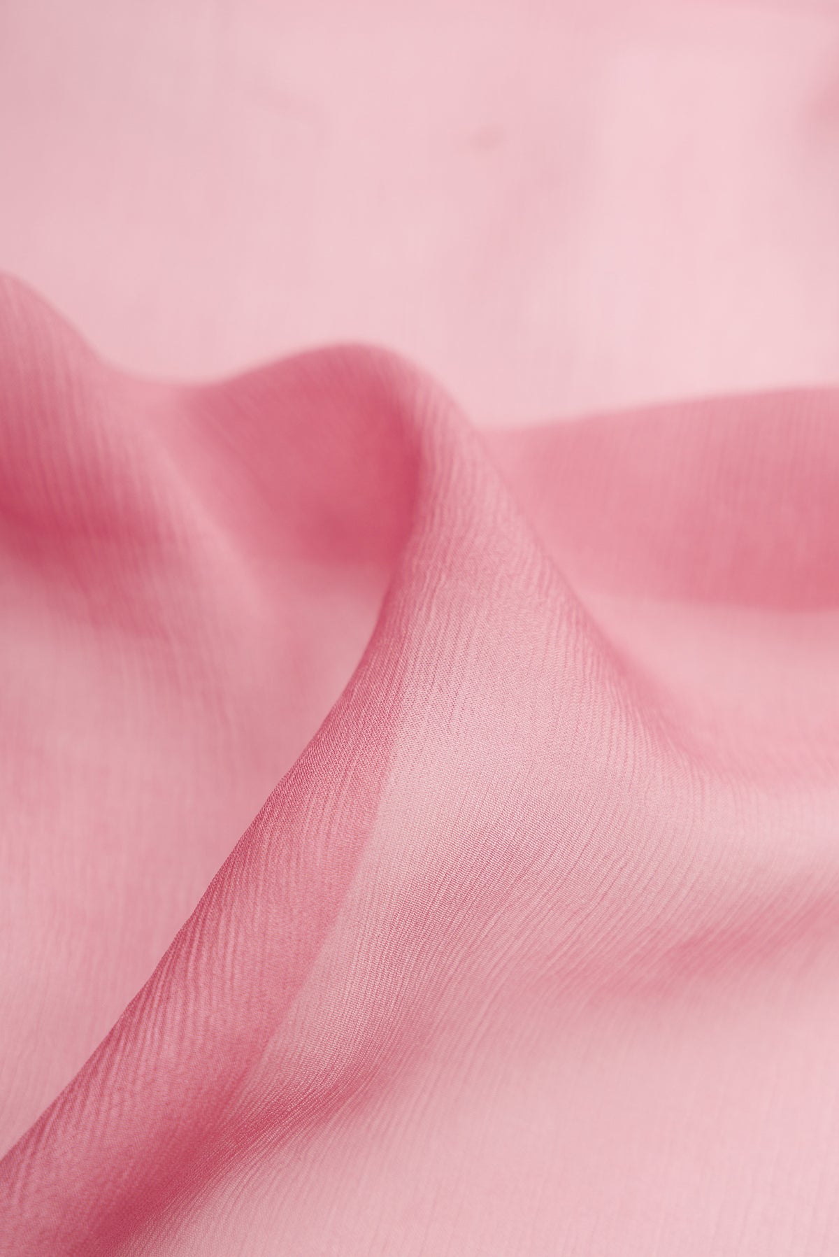 Close up of Rose Gold Mysore Chiffon Saree with Plain Body and Zari Border.  displaying folds