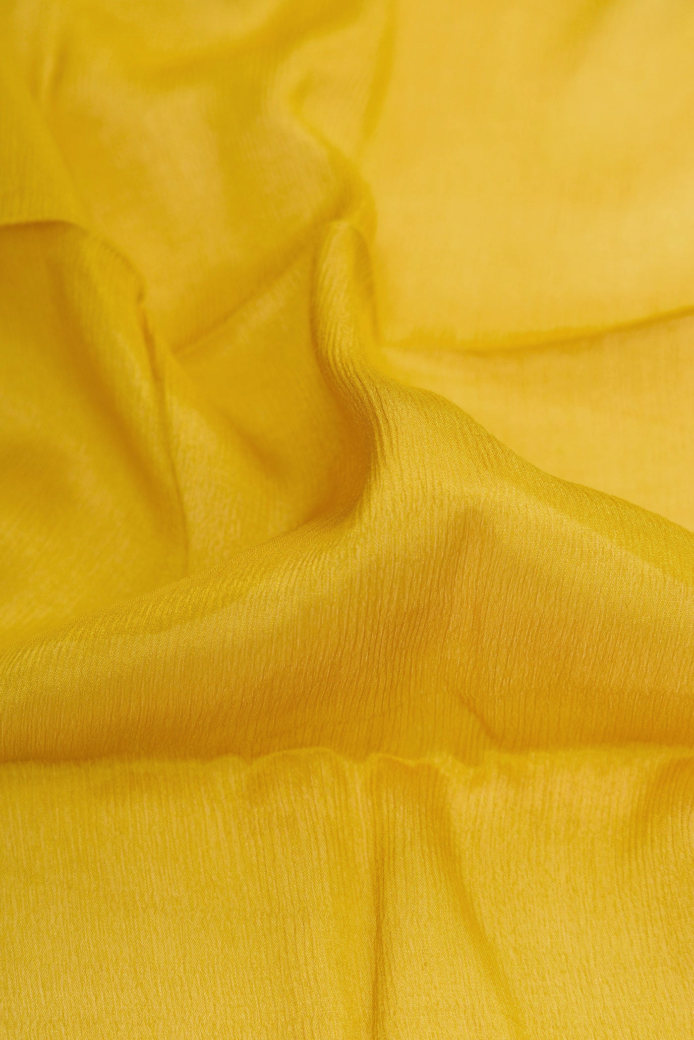 Close up of Mehandi Green Mysore Chiffon Saree with Plain Body and Zari Border.  displaying folds