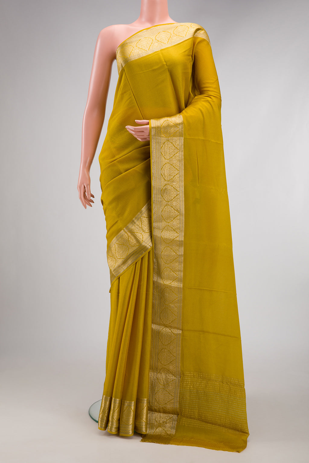 Mehandi Green Mysore Chiffon Saree with Plain Body and Zari Border.  displayed on a mannequin