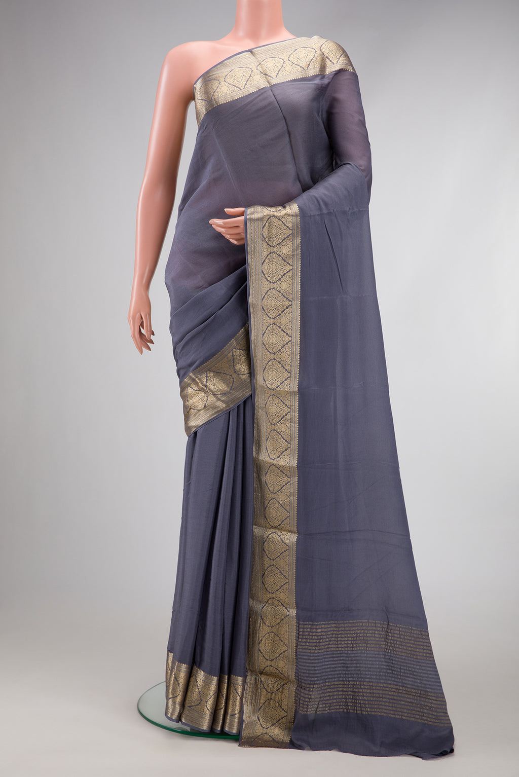 Grey Georgette Saree with Plain Body and Zari Border.  displayed on a mannequin