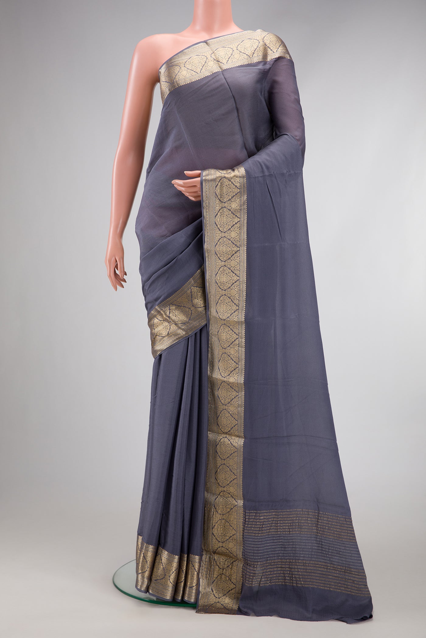 Grey Georgette Saree with Plain Body and Zari Border.  displayed on a mannequin