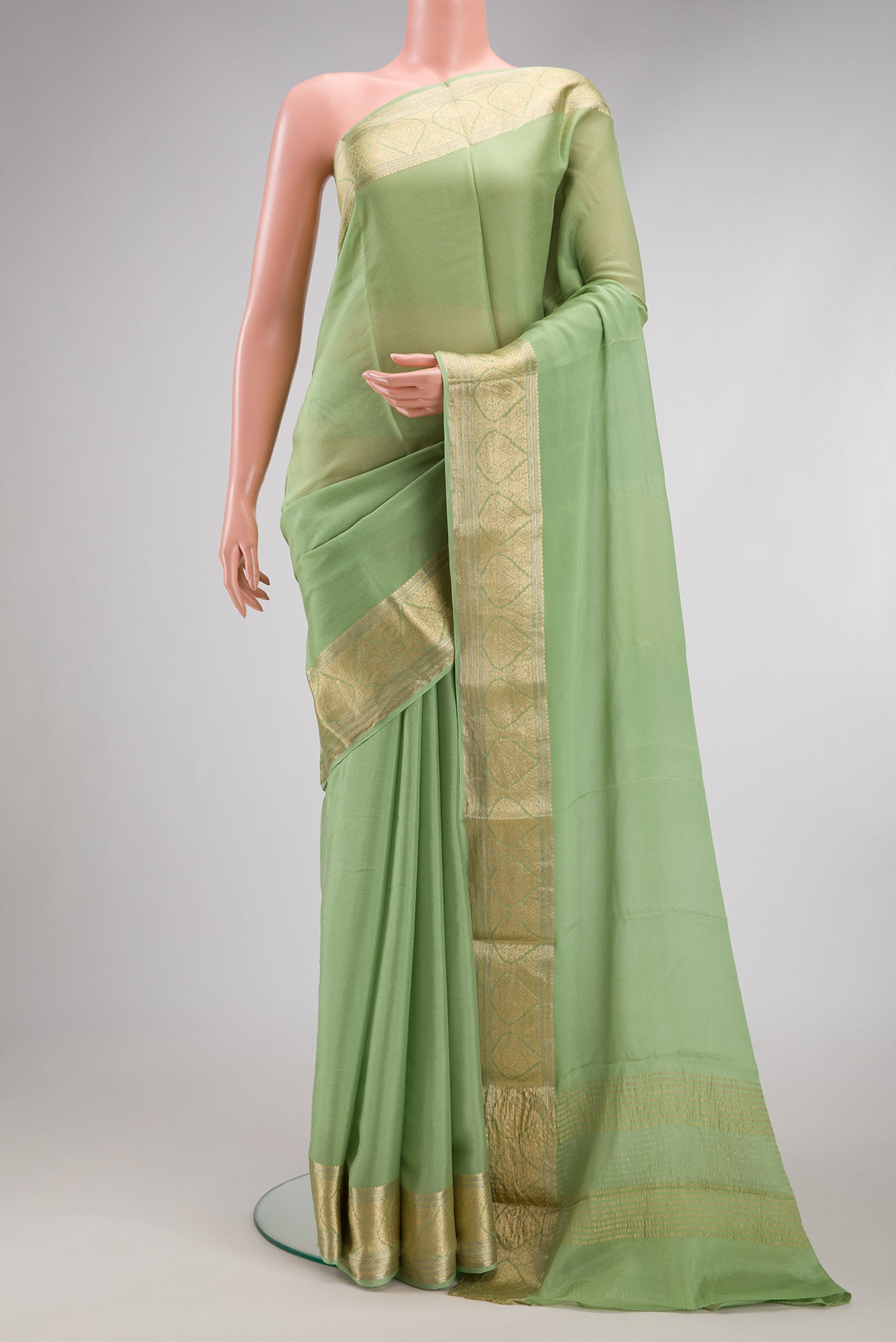 Pista Green Mysore Chiffon Saree with Plain Body and Zari Border.  displayed on a mannequin