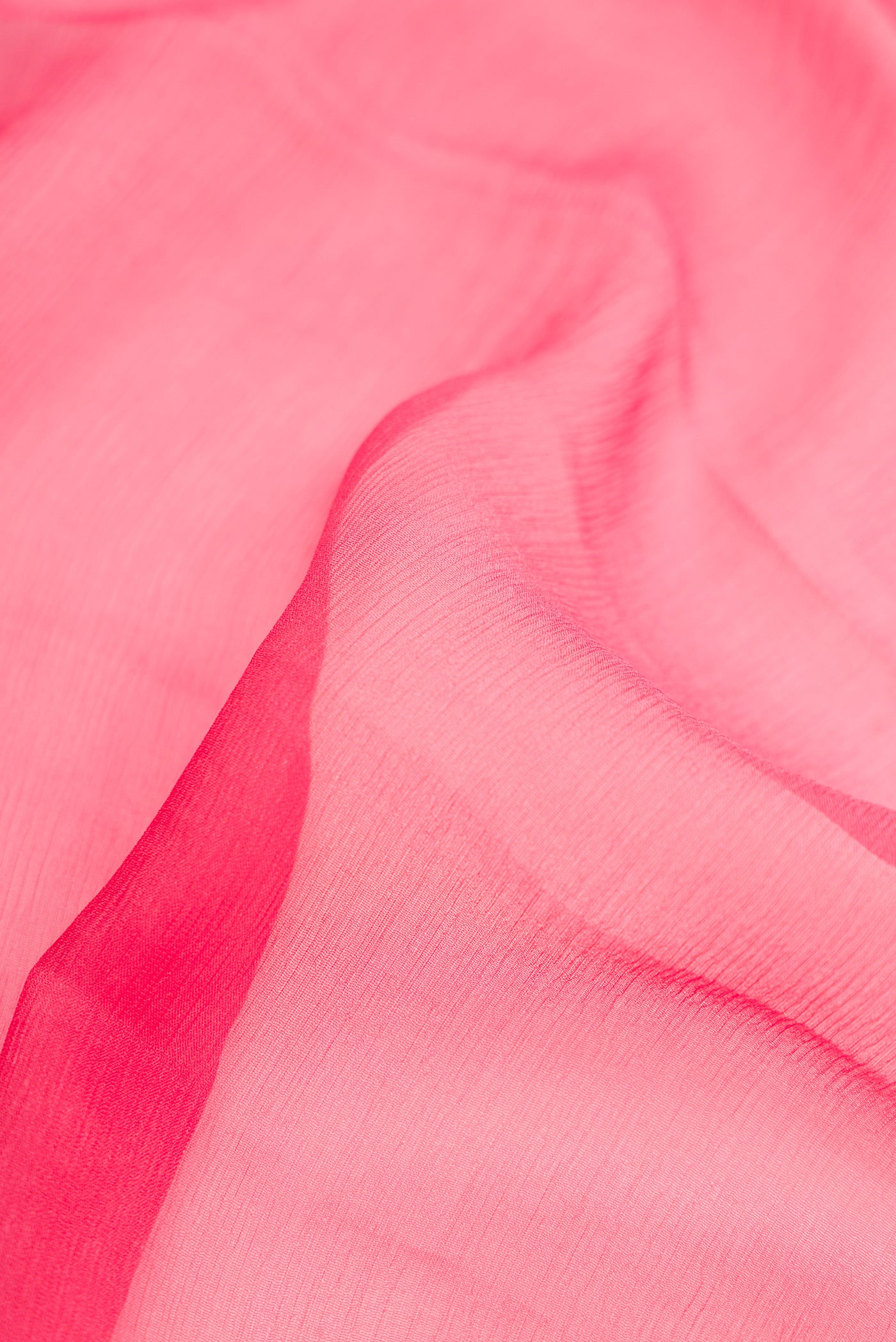 Close up of Pink Dual Tone Mysore Chiffon Saree with Plain Body and Zari Border.  displaying folds