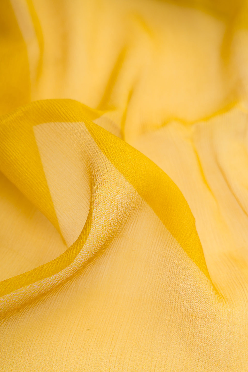 Close up of Mehandi Green Mysore Chiffon Saree with Plain Body and Zari Border.  displaying folds