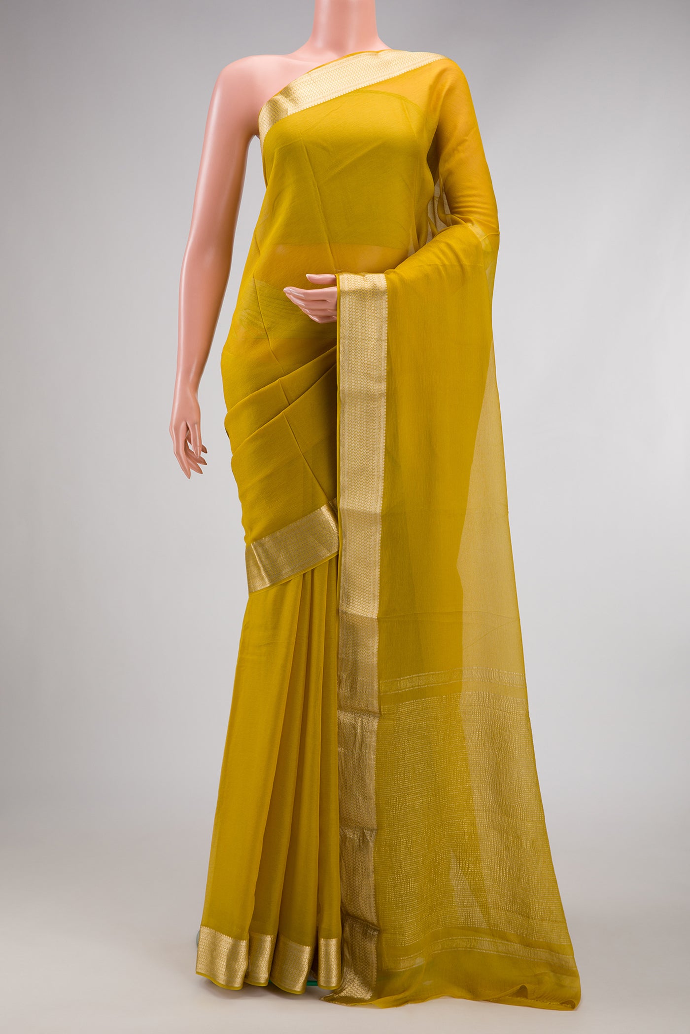 Mehandi Green Mysore Chiffon Saree with Plain Body and Zari Border.  displayed on a mannequin