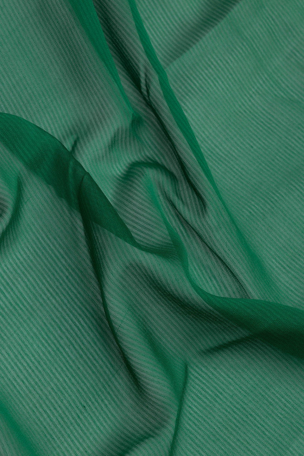 Close up of Green Georgette Saree with Stripes on the body and Zari Border.  displaying folds