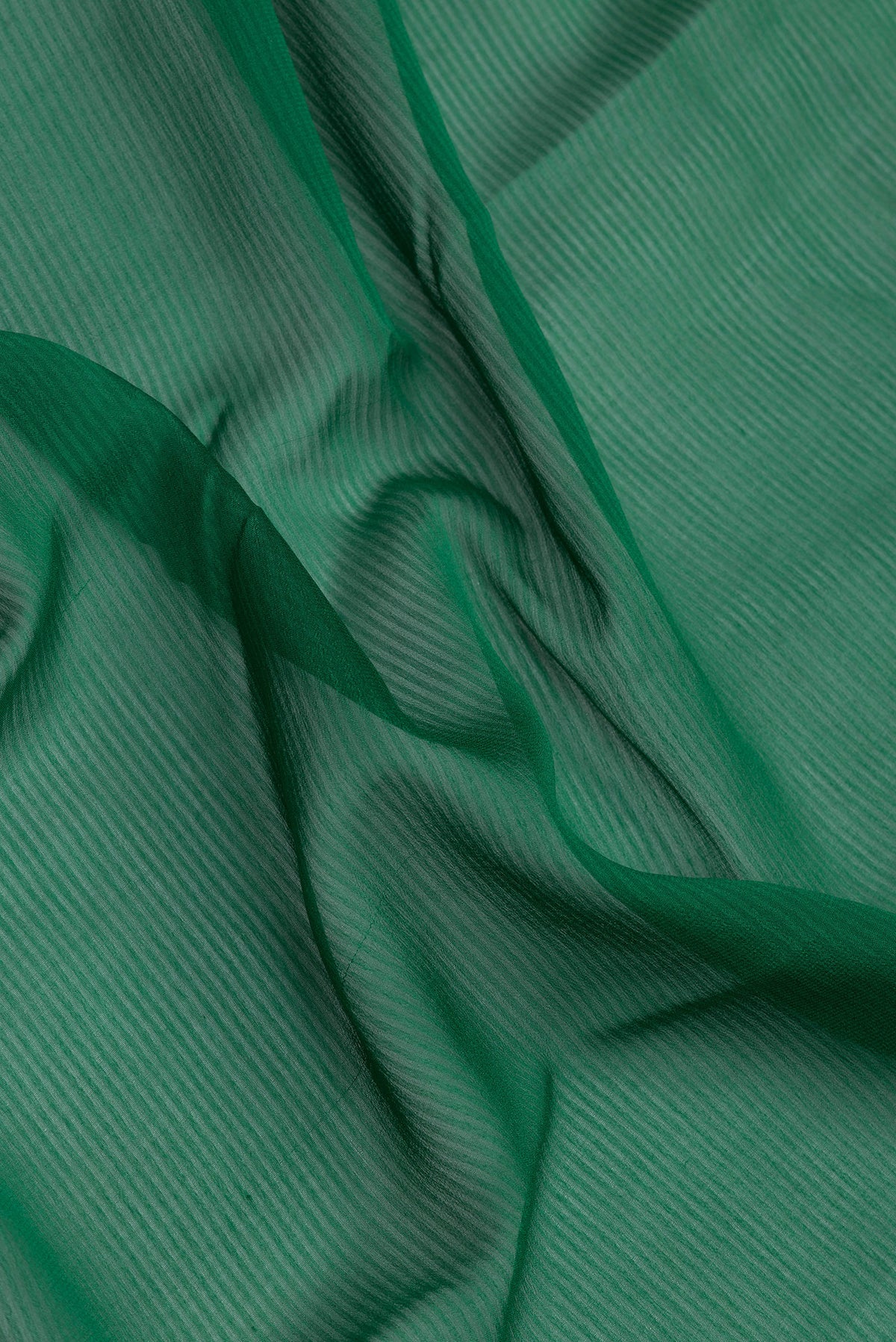 Close up of Green Georgette Saree with Stripes on the body and Zari Border.  displaying folds