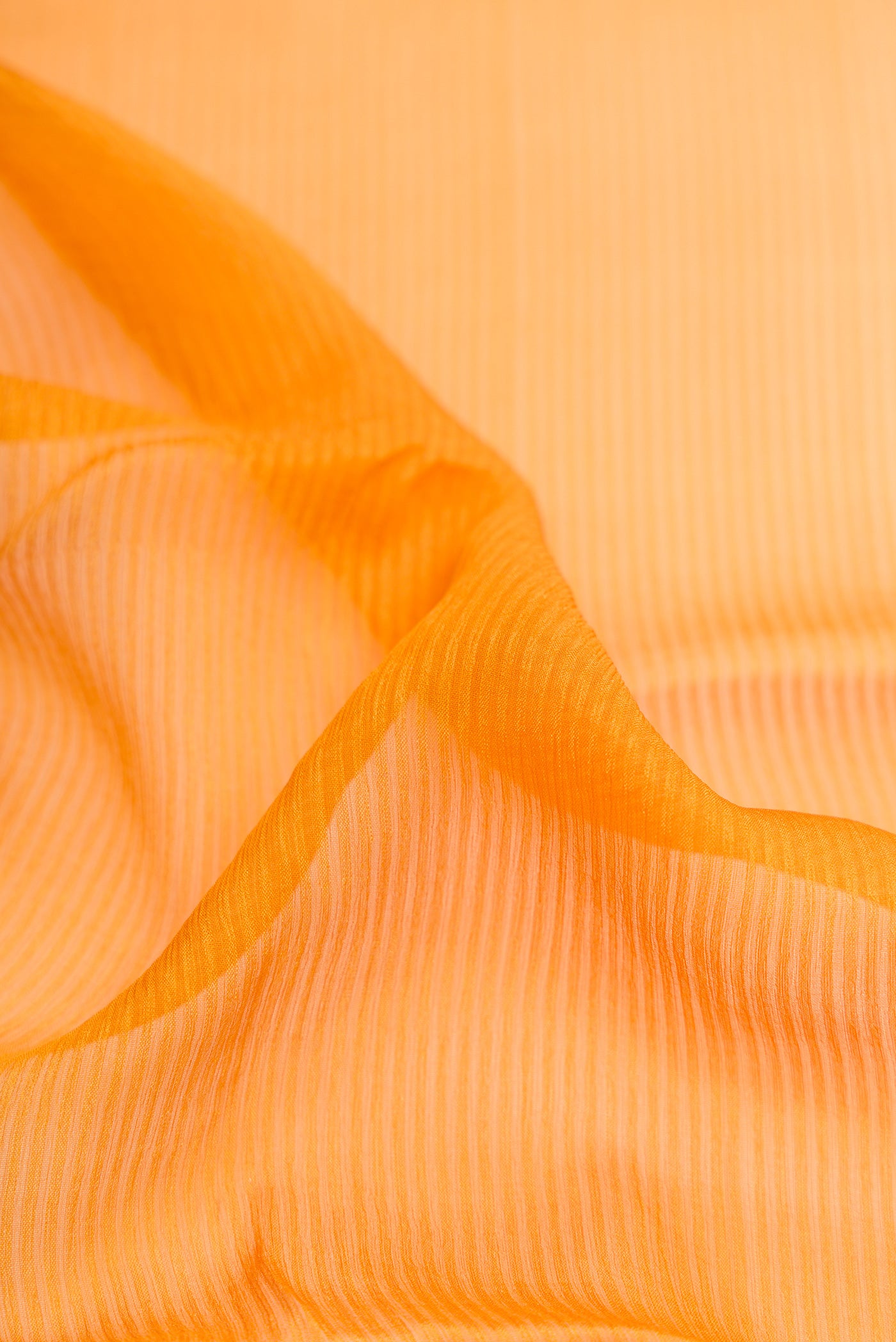 Close up of Mustard Mysore Georgette Saree with Stripes on the body and Zari Border.  displaying folds