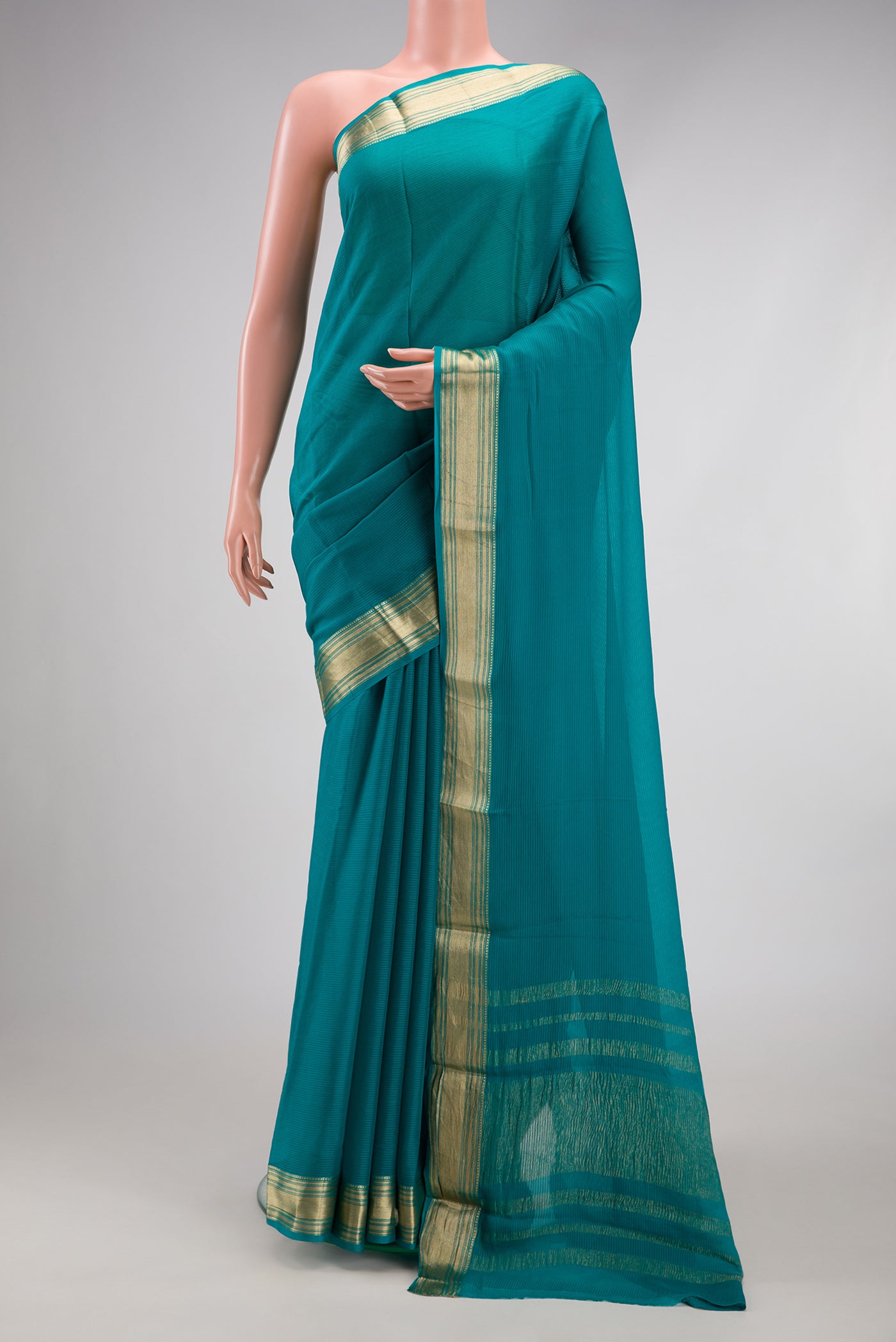 Peacock Blue Mysore Georgette Saree with Stripes on the body and Zari Border.  displayed on a mannequin