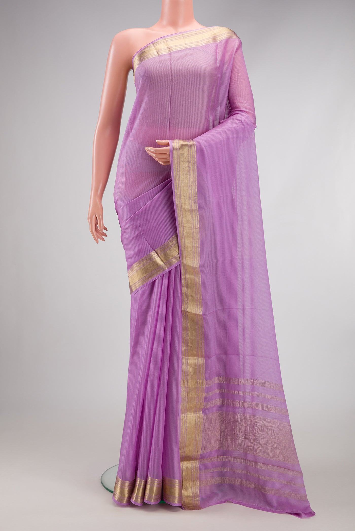Lavender Mysore Georgette Saree with Stripes on the body and Zari Border.  displayed on a mannequin