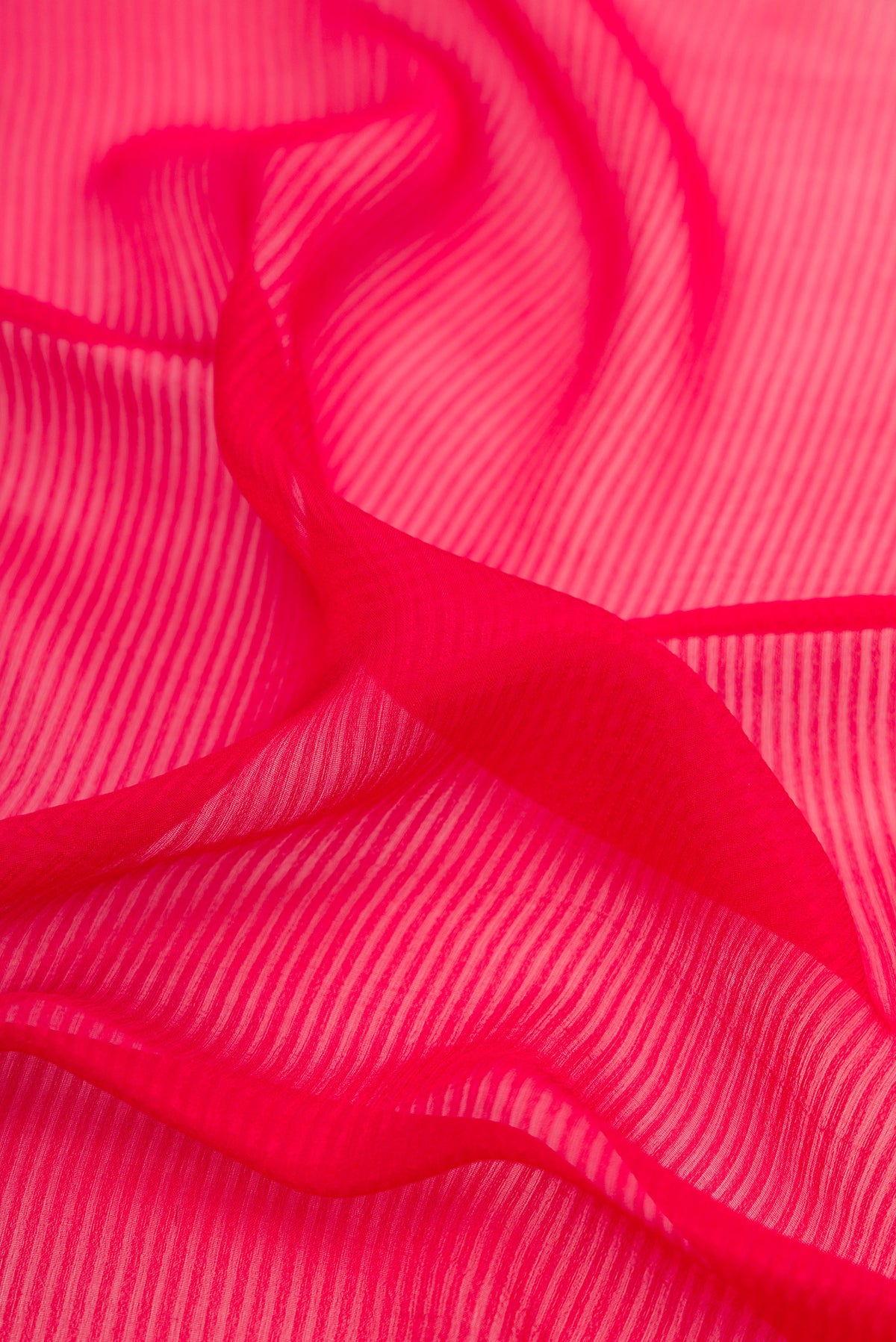 Close up of Dark Pink Mysore Georgette Saree with Stripes on the body and Zari Border.  displaying folds