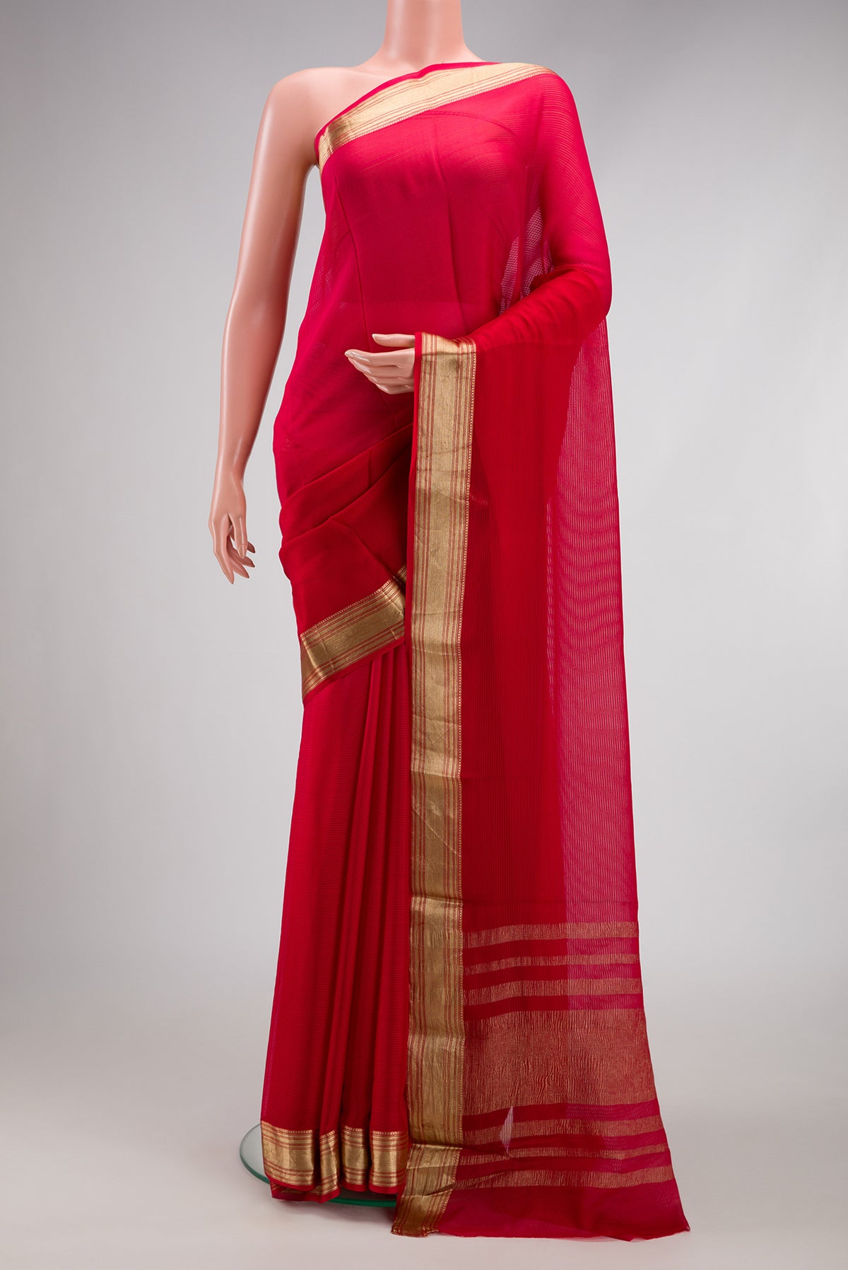 Dark Pink Mysore Georgette Saree with Stripes on the body and Zari Border.  displayed on a mannequin
