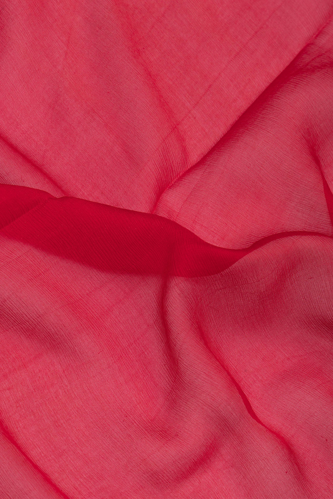 Close up of Red Mysore Chiffon Saree with Plain Body and Zari Border.  displaying folds