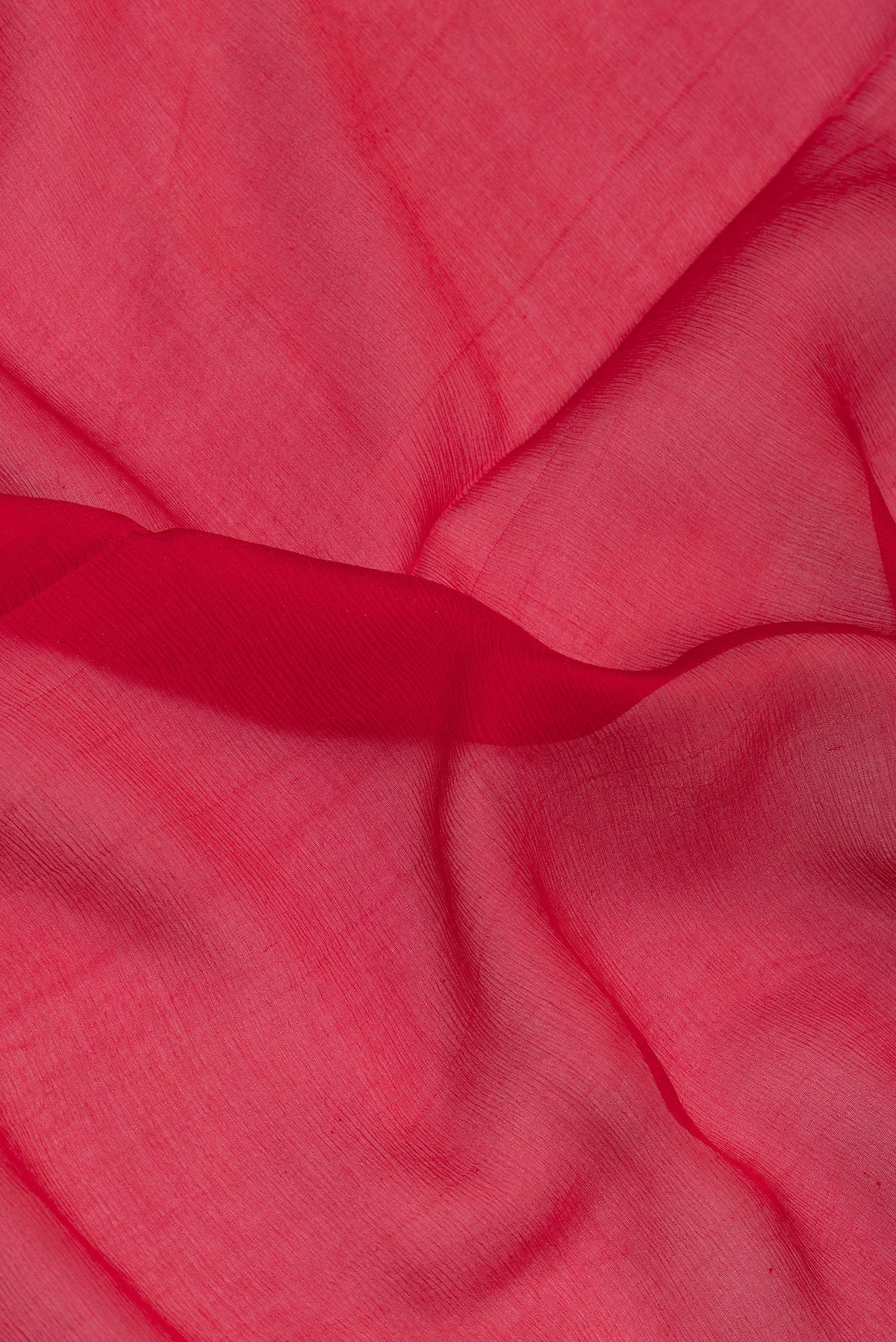 Close up of Red Mysore Chiffon Saree with Plain Body and Zari Border.  displaying folds