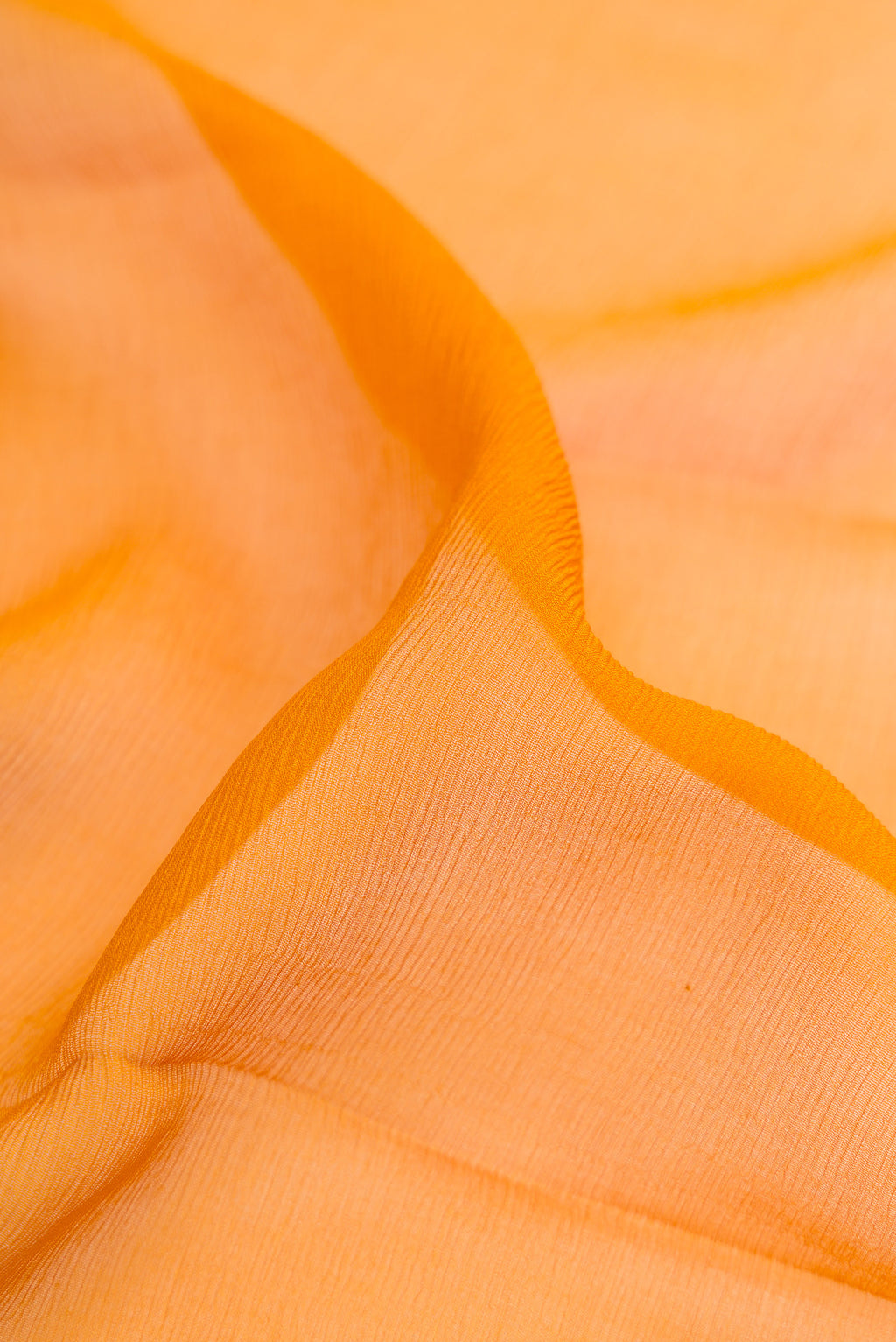 Close up of Mustard Mysore Chiffon Saree with Plain Body and Fancy Border.  displaying folds