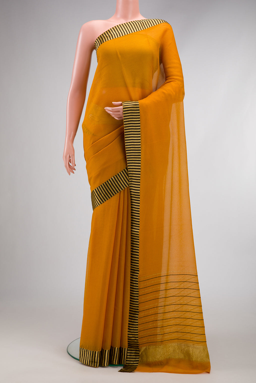 Mustard Mysore Chiffon Saree with Plain Body and Fancy Border.  displayed on a mannequin