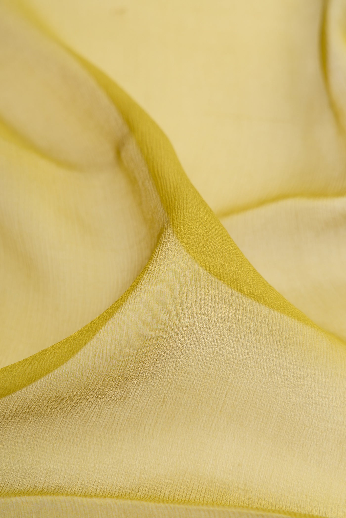 Close up of Mehandi Green Mysore Chiffon Saree with Plain Body and Zari Border.  displaying folds