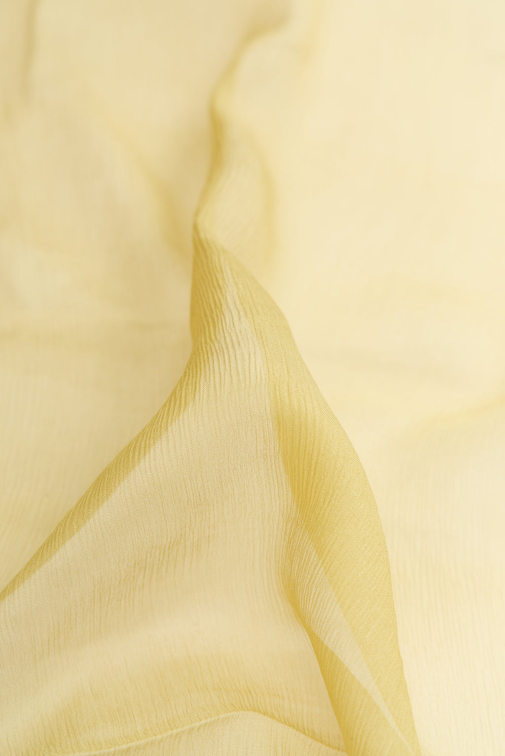 Close up of Pista Green Dual Tone Mysore Chiffon Saree with Plain Body and Zari Border.  displaying folds
