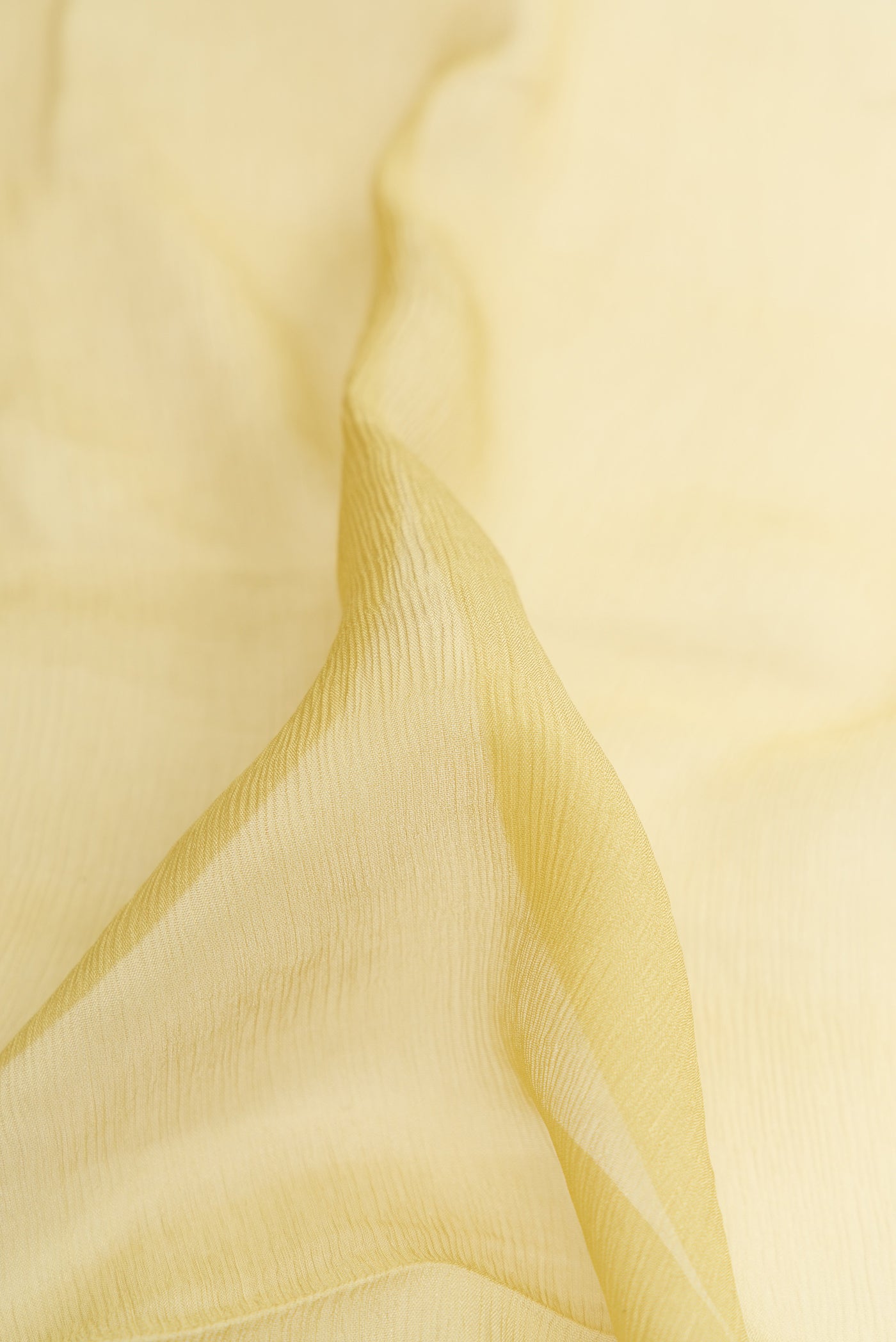 Close up of Pista Green Dual Tone Mysore Chiffon Saree with Plain Body and Zari Border.  displaying folds