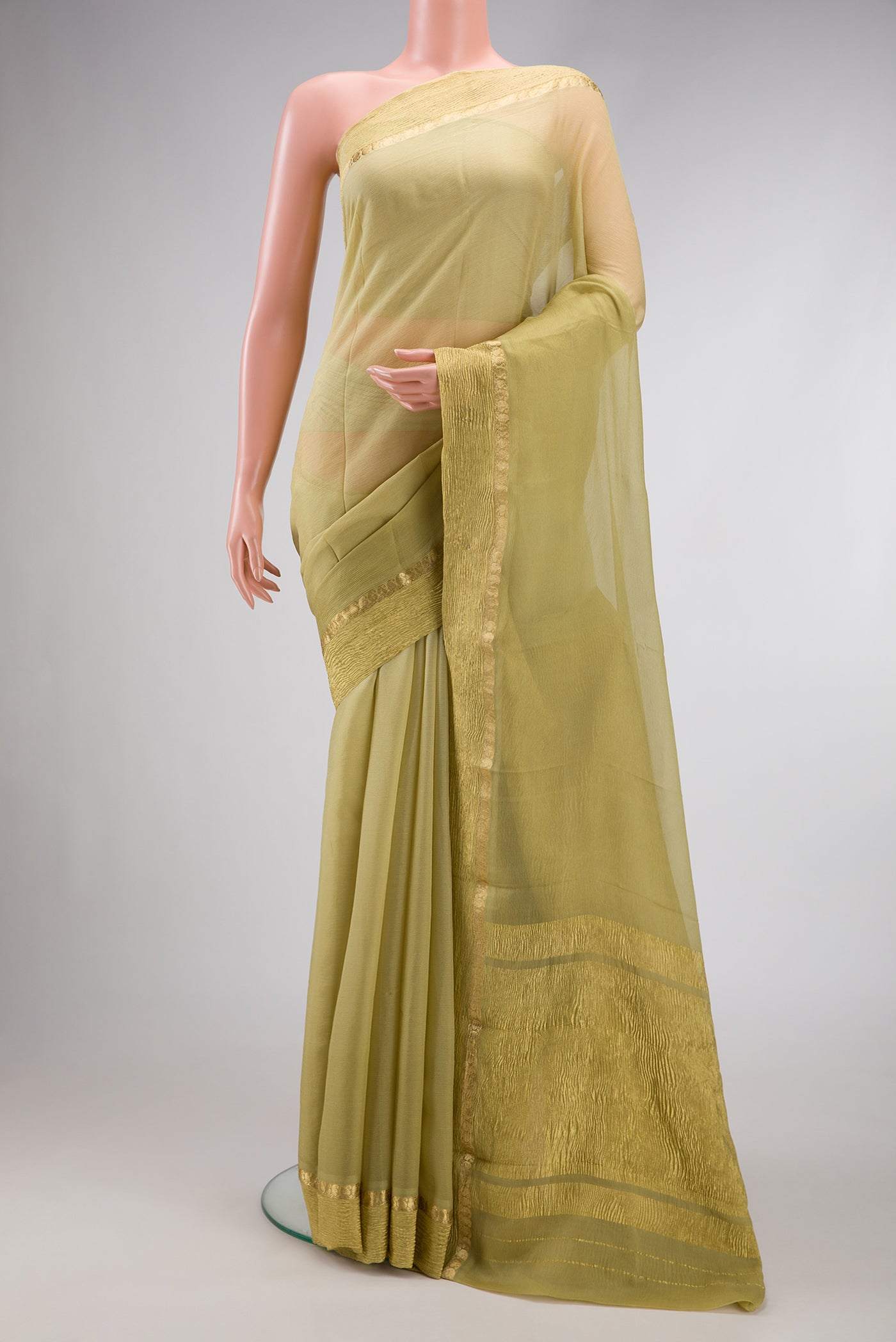 Pista Green Dual Tone Mysore Chiffon Saree with Plain Body and Zari Border.  displayed on a mannequin