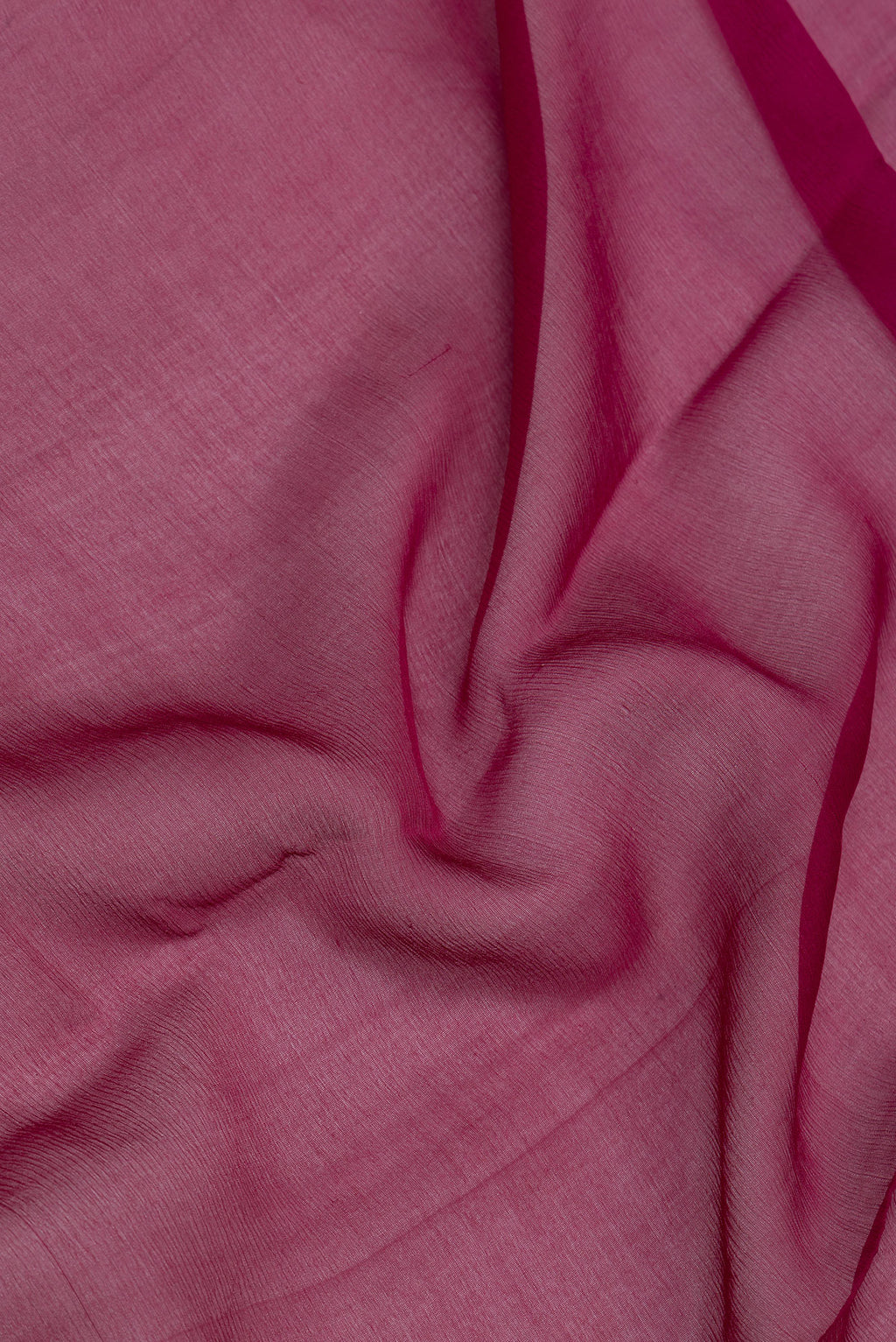 Close up of Maroon Mysore Chiffon Saree with Plain Body and Zari Border.  displaying folds