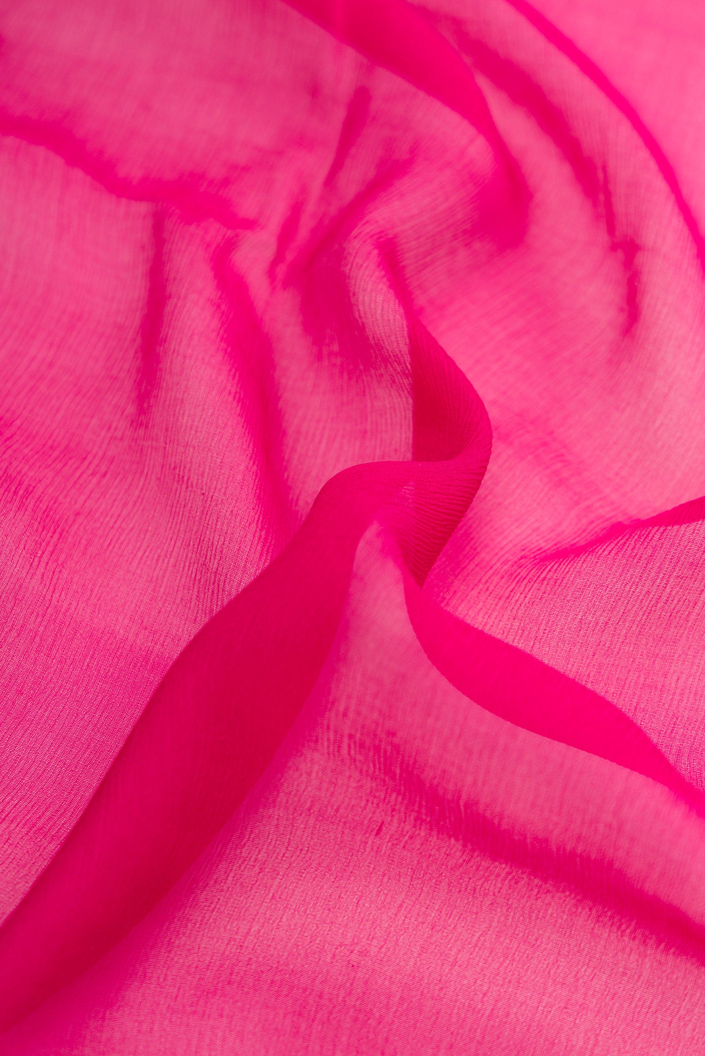 Close up of Pink Dual Tone Mysore Chiffon Saree with Plain Body and Zari Border.  displaying folds
