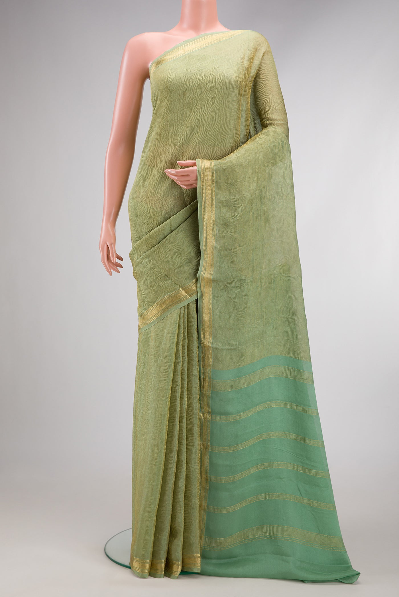 Pista Green Dual Tone Mysore Georgette Saree with Plain Body and Zari Border.  displayed on a mannequin