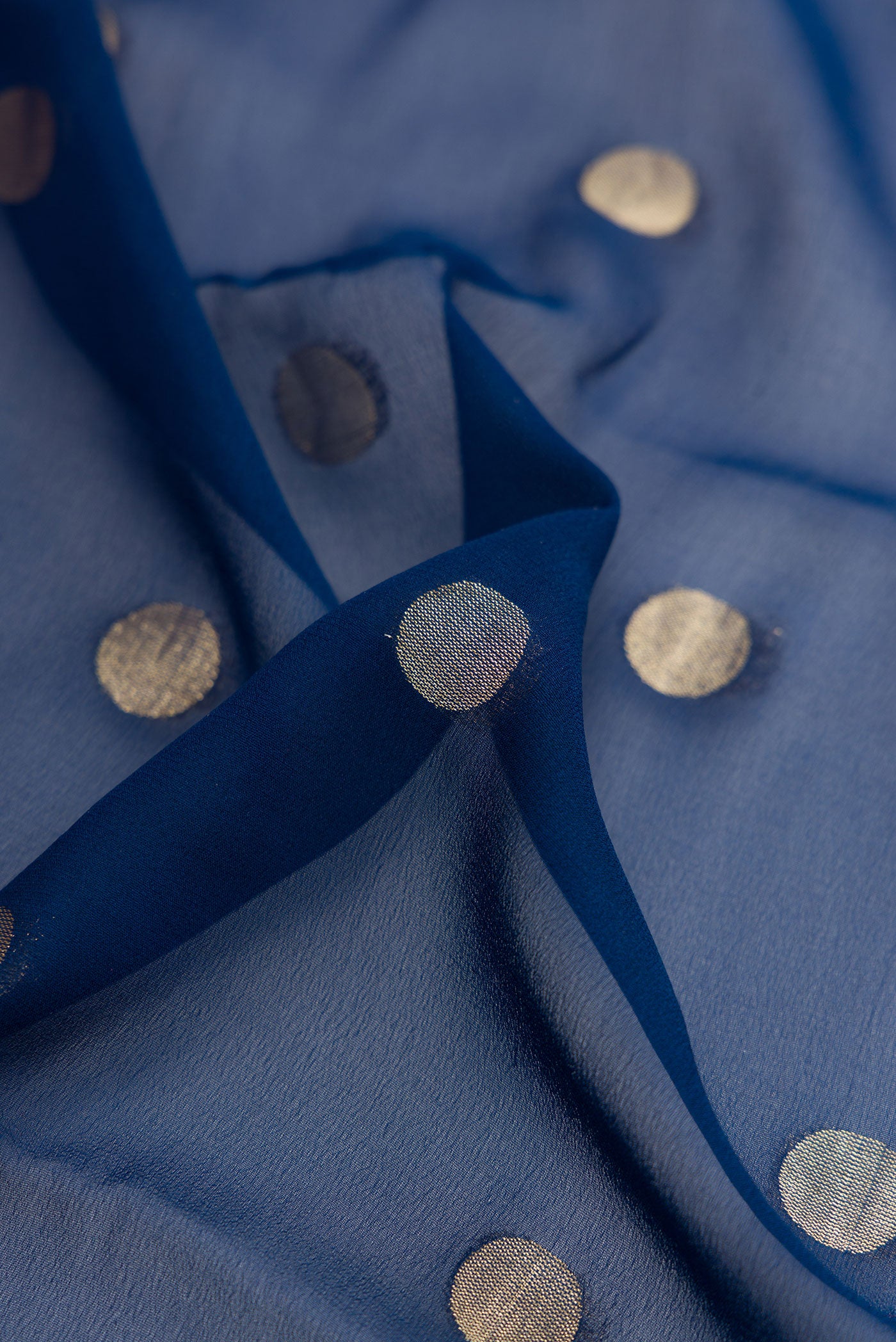 Close up of Navy Blue Mysore Georgette Saree with Zari Butta on the body and Zari Border.  displaying folds