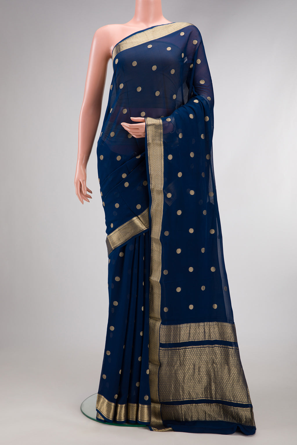 Navy Blue Mysore Georgette Saree with Zari Butta on the body and Zari Border.  displayed on a mannequin