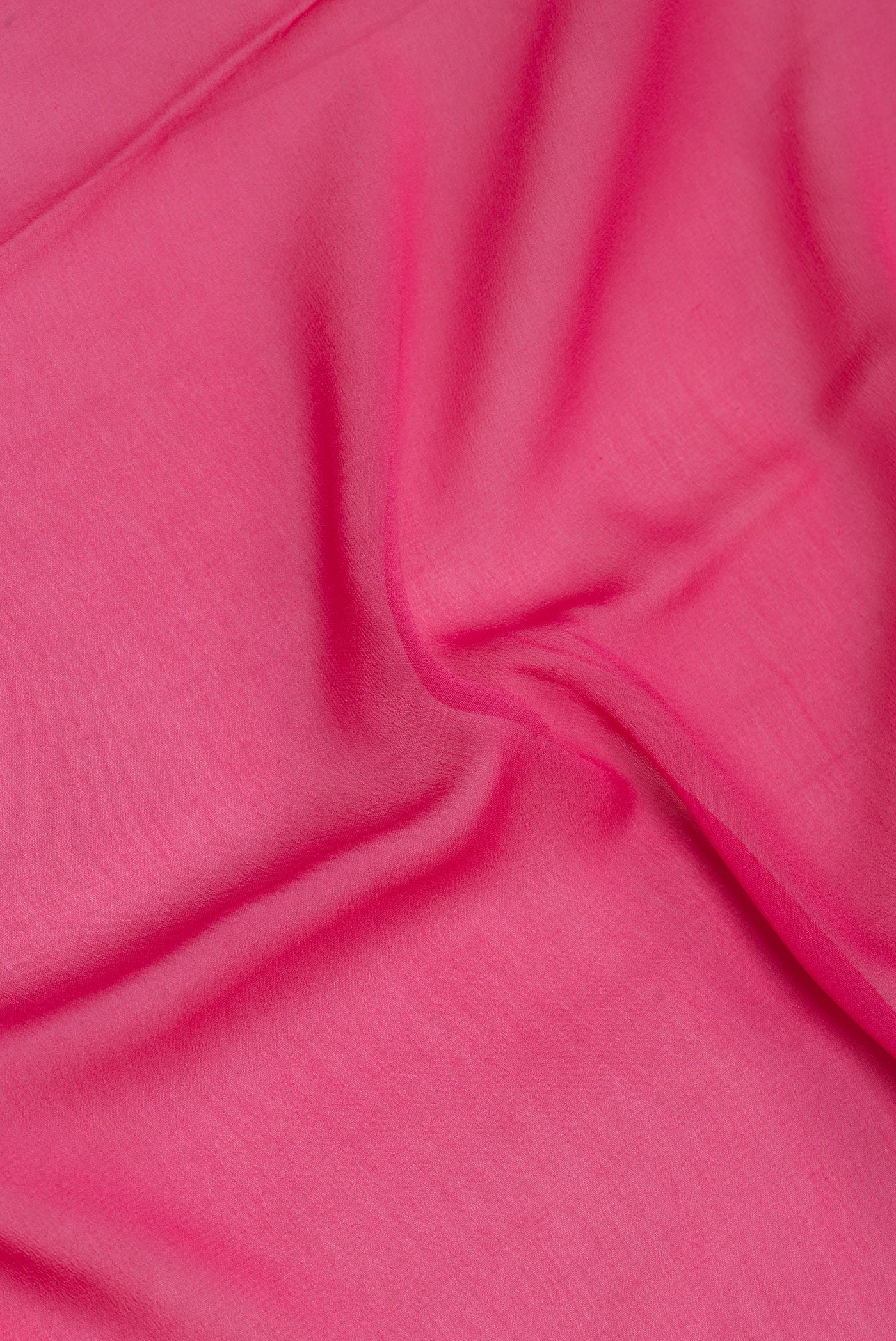 Close up of Pink Mysore Georgette Saree with Plain Body and Zari Border.  displaying folds