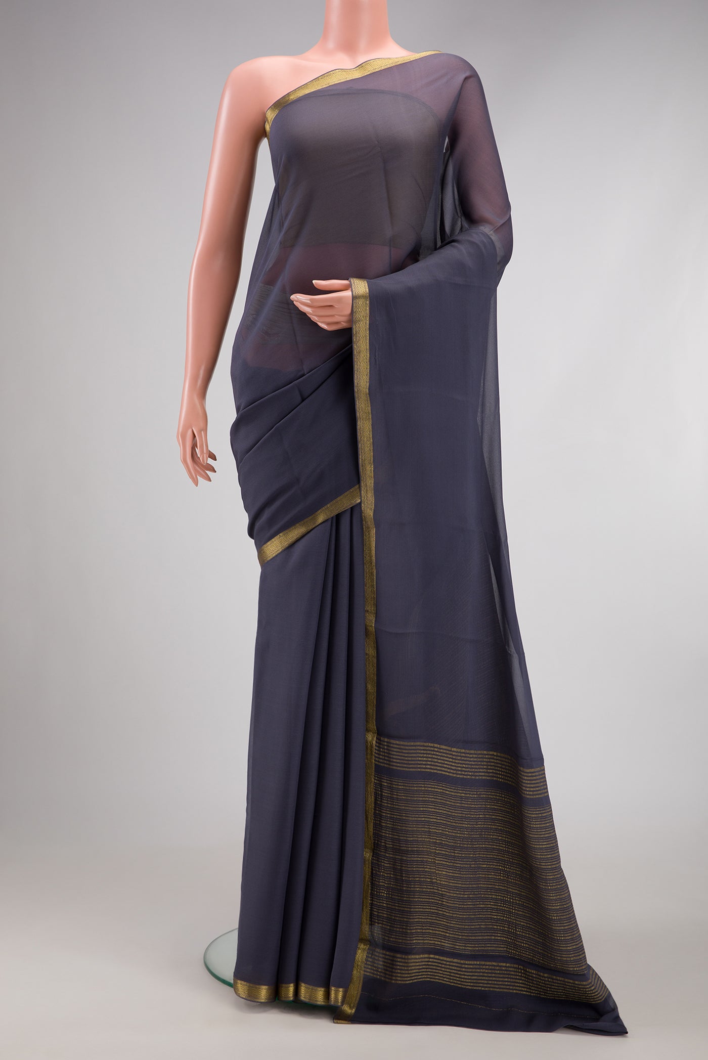 Grey Mysore Georgette Saree with Plain Body and Zari Border.  displayed on a mannequin