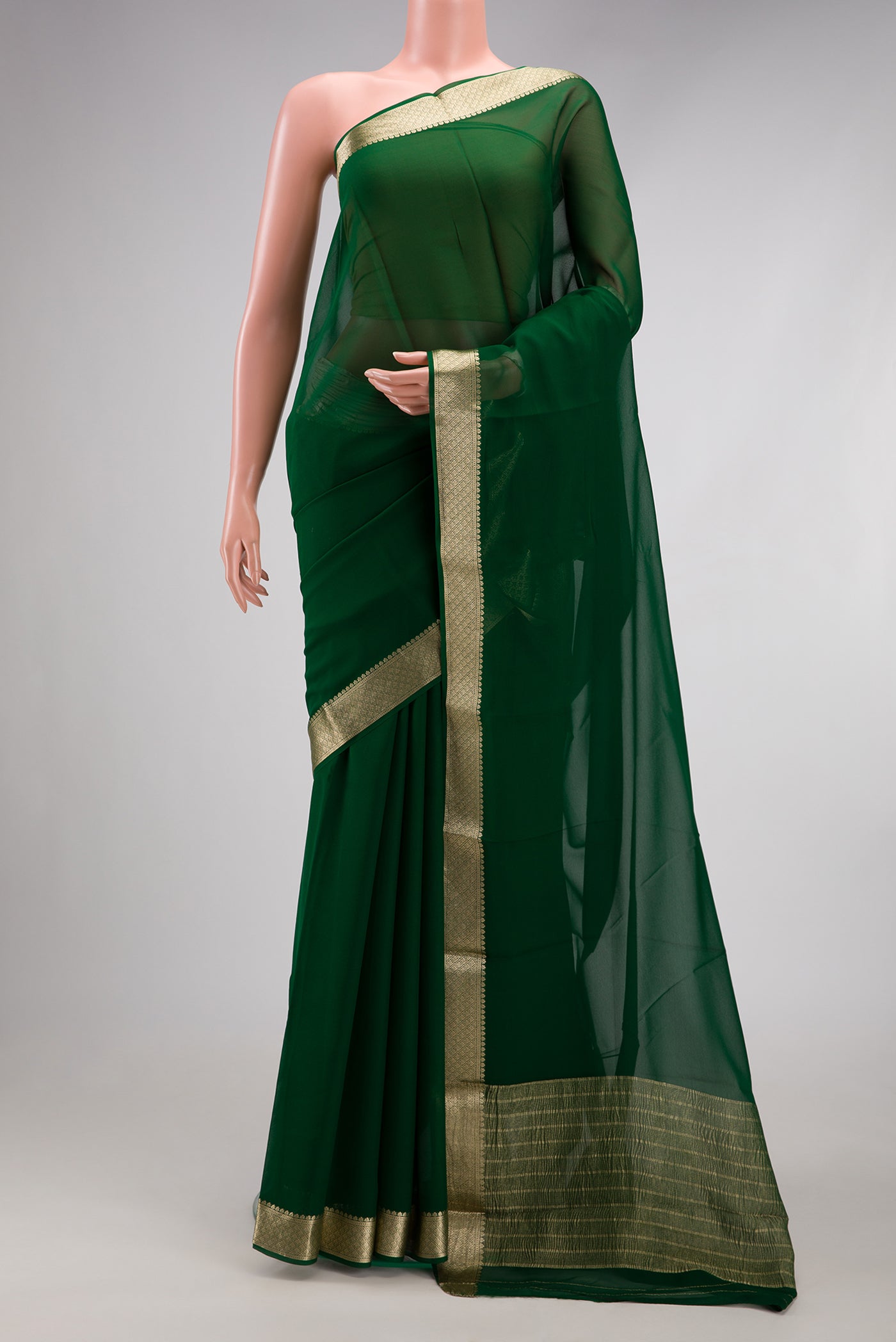 Bottle Green Mysore Georgette Saree with Plain Body and Zari Border.  displayed on a mannequin