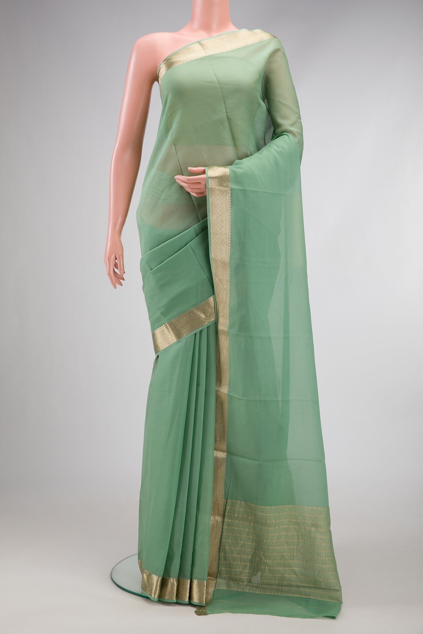 Light Green Dual Tone Georgette Saree with Plain Body and Zari Border.  displayed on a mannequin