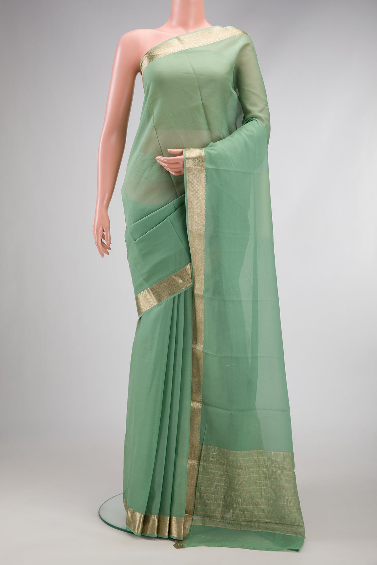 Light Green Dual Tone Georgette Saree with Plain Body and Zari Border.  displayed on a mannequin
