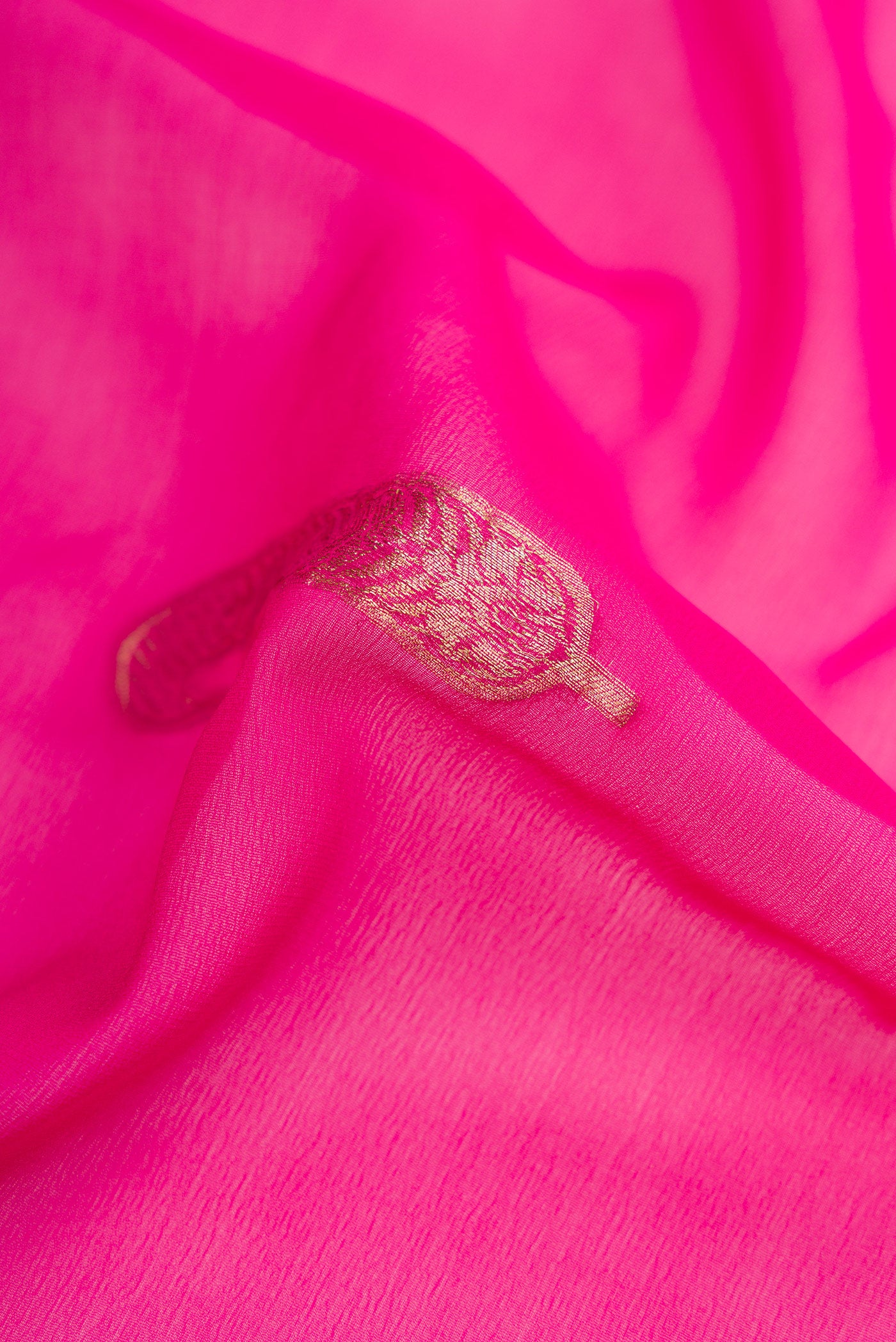 Close up of Pink Dual Tone Mysore Georgette Saree with Zari Butta on the body and Zari Border.  displaying folds