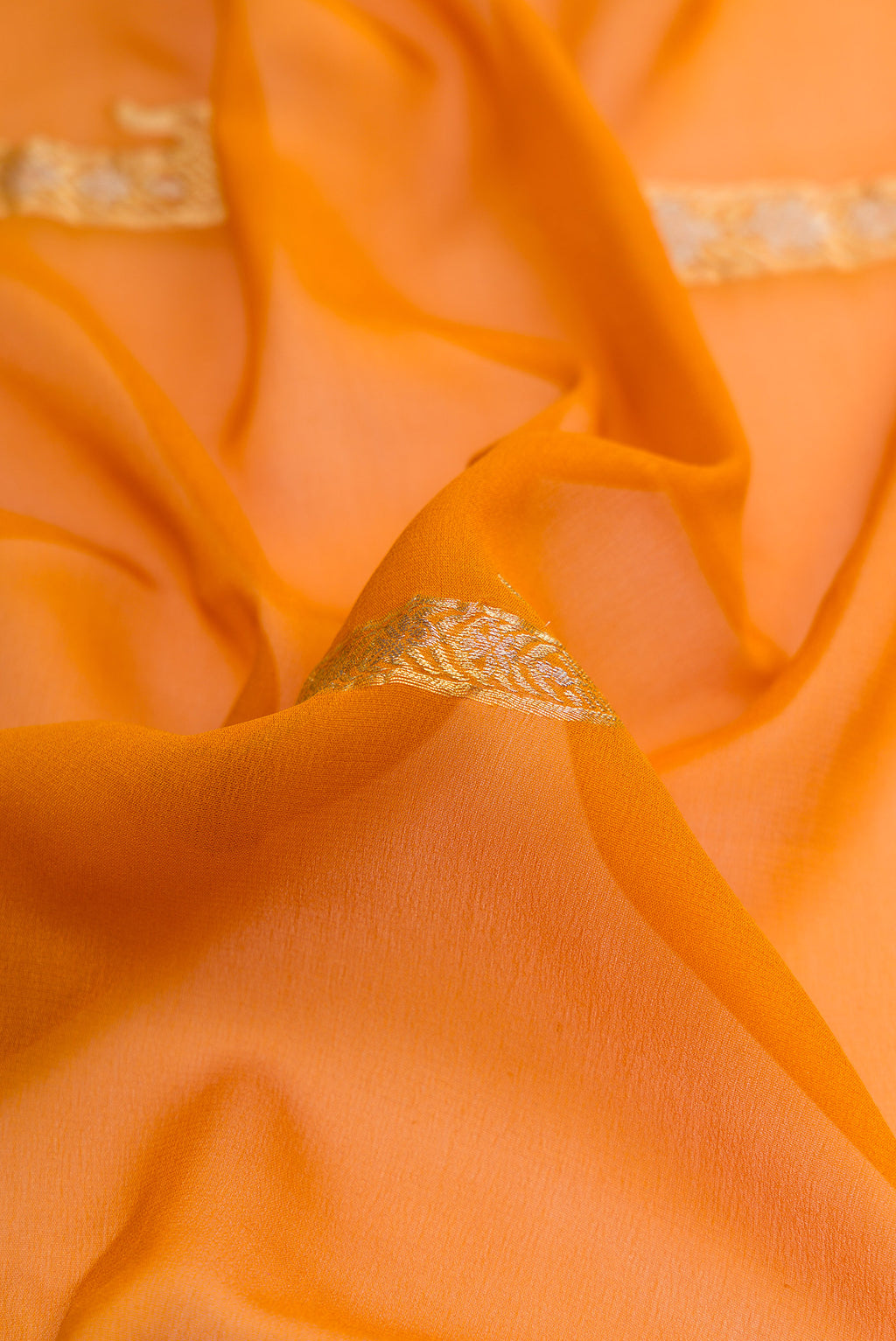 Close up of Mustard Dual Tone Mysore Georgette Saree with Zari Butta on the body and Zari Border.  displaying folds