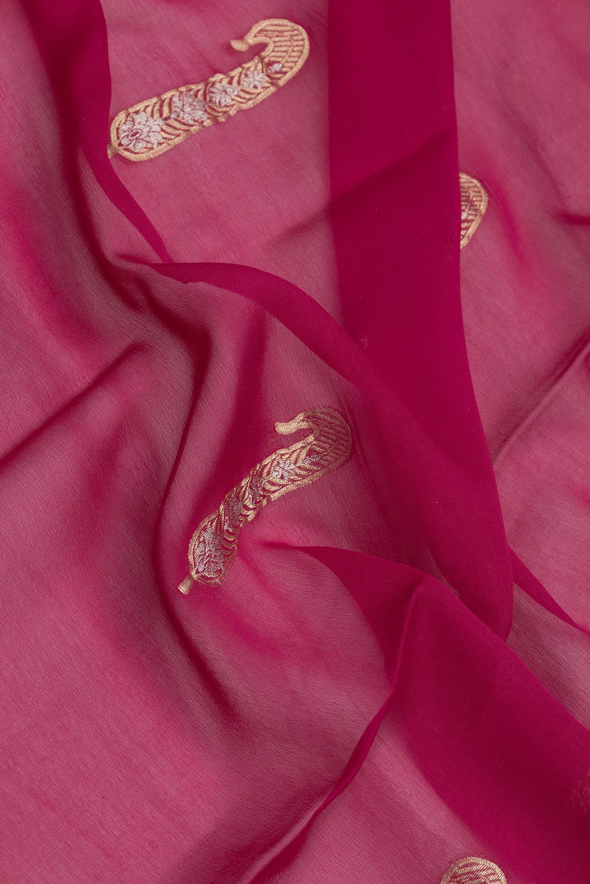 Close up of Magenta Dual Tone Mysore Georgette Saree with Zari Butta on the body and Zari Border.  displaying folds