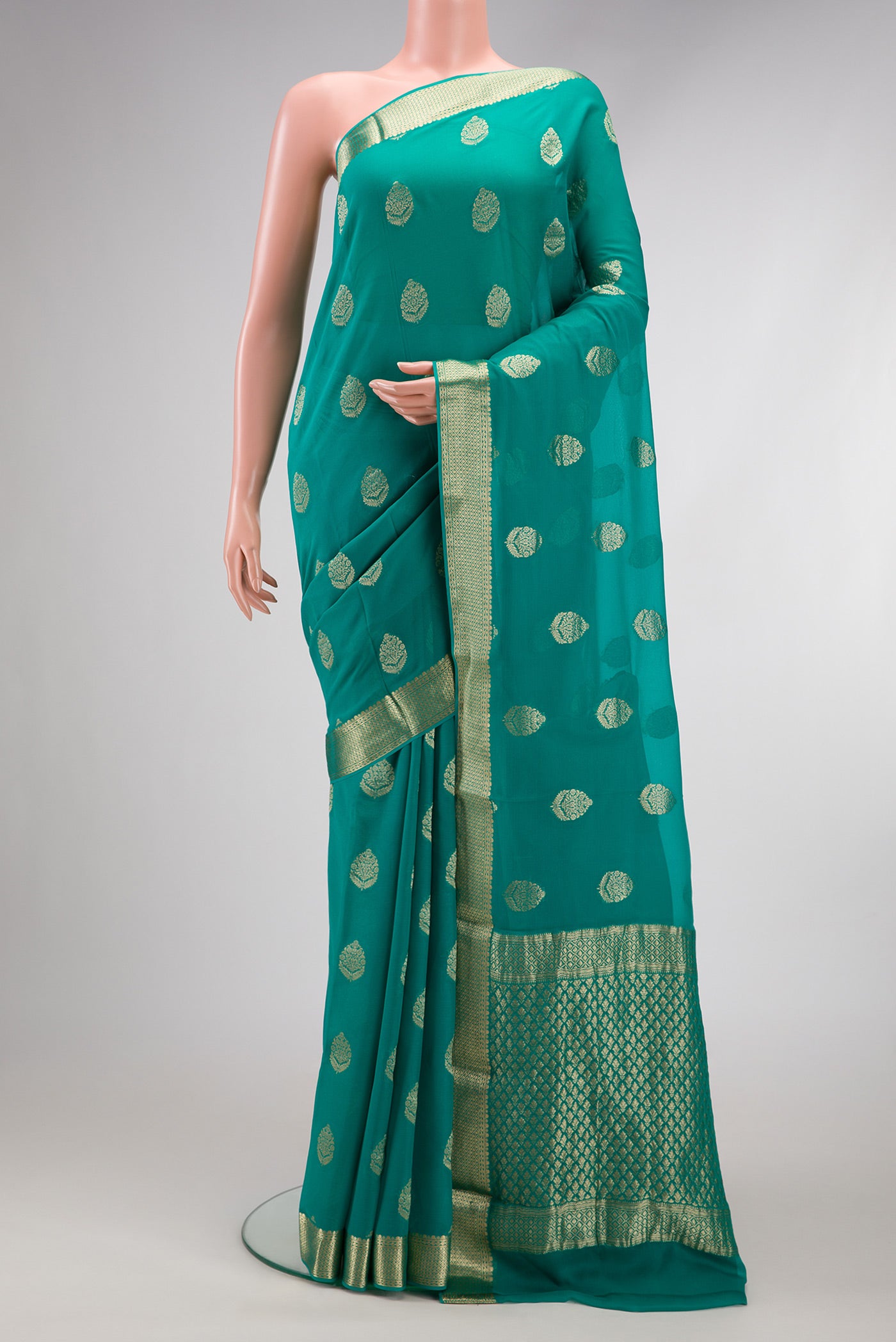 Peacock Blue Mysore Georgette Saree with Zari Butta on the body and Zari Border.  displayed on a mannequin
