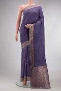Lavender Blended Bandhani Silk Saree with Bandhani Print on the body and Zari Border.  displayed on a mannequin