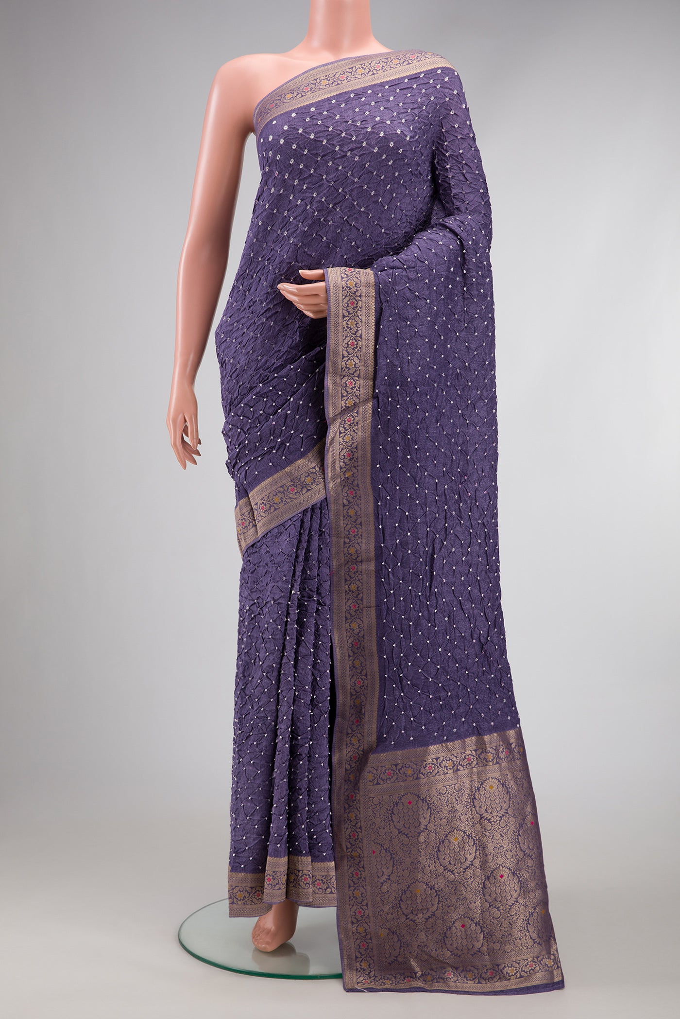 Lavender Blended Bandhani Silk Saree with Bandhani Print on the body and Zari Border.  displayed on a mannequin