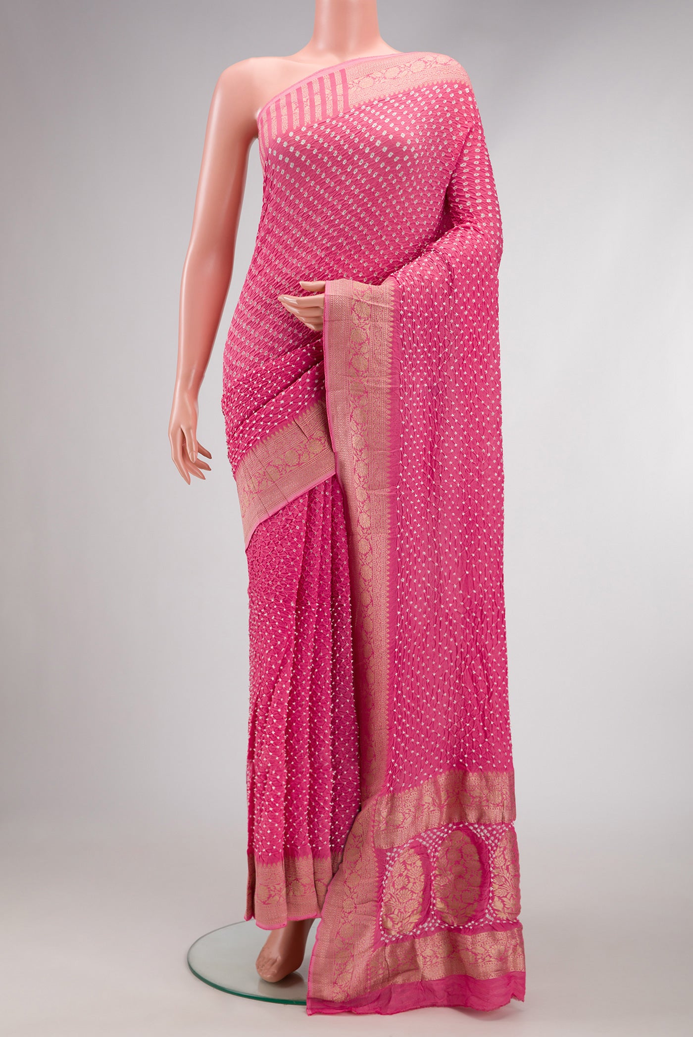 Pink Dual Tone Bandhani Silk Saree with Bandhani Print on the body and Zari Border.  displayed on a mannequin