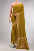 Green Dual Tone Bandhani Silk Saree with Bandhani Print on the body and Zari Border.  displayed on a mannequin