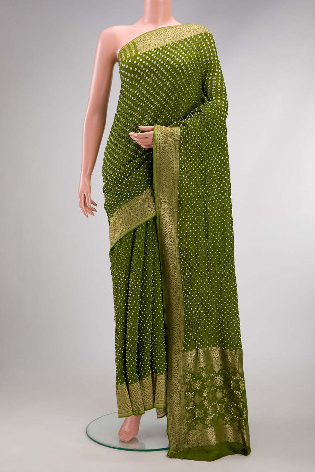 Mehandi Green Dual Tone Bandhani Silk Saree with Bandhani Print on the body and Zari Border.  displayed on a mannequin