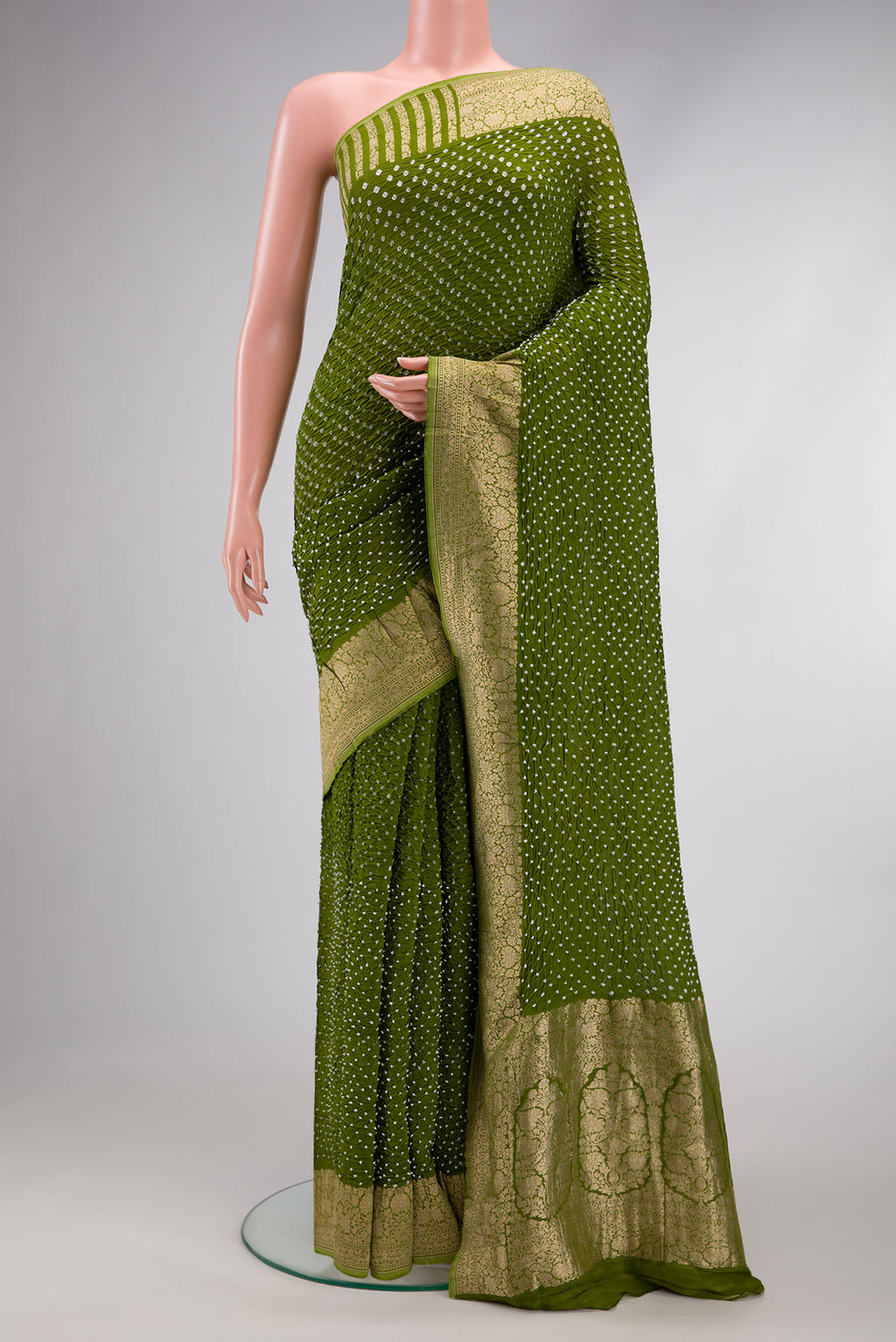 Green Dual Tone Bandhani Silk Saree with Bandhani Print on the body and Zari Border.  displayed on a mannequin